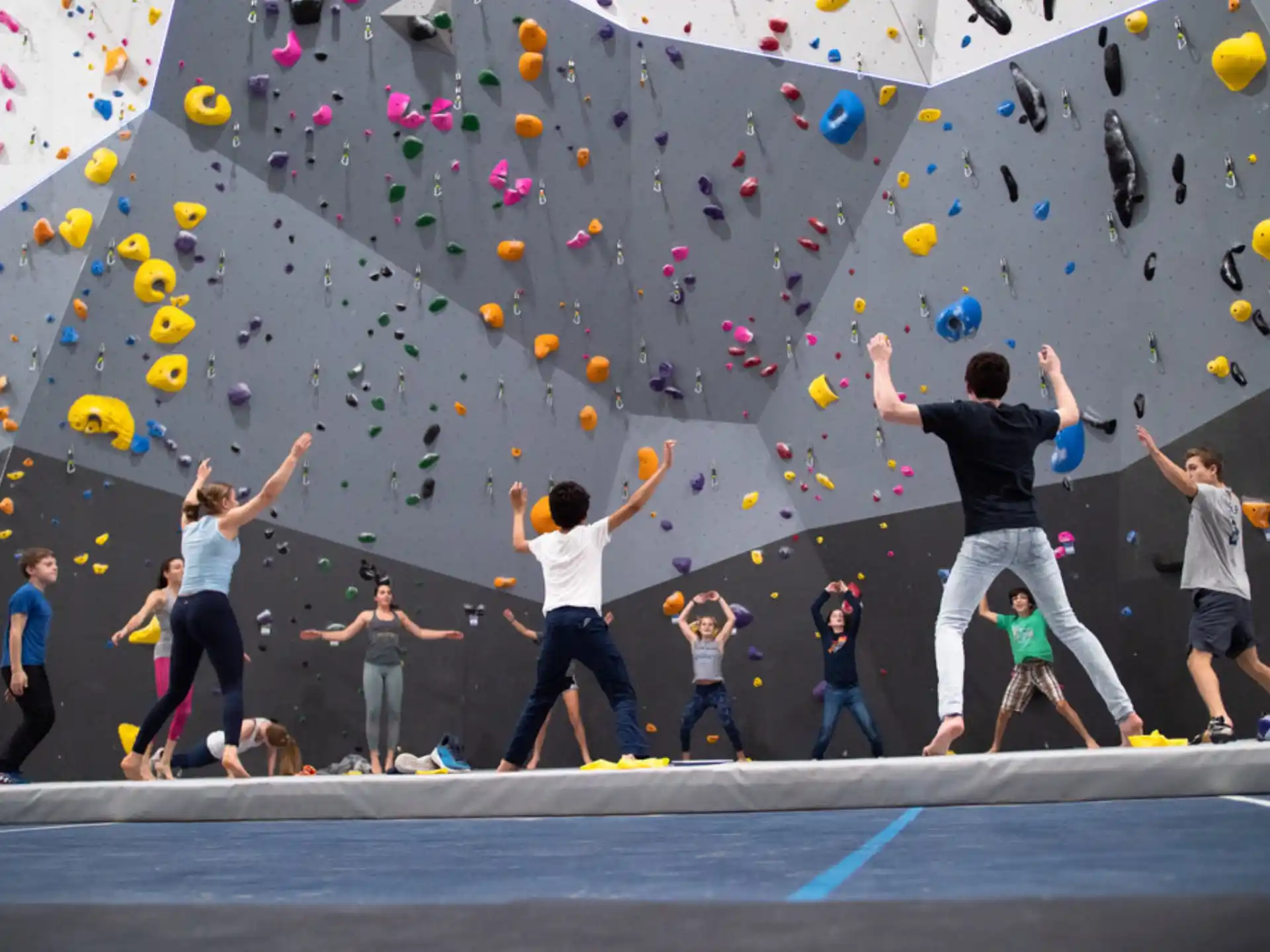 a group of people jumping in the air with balloons