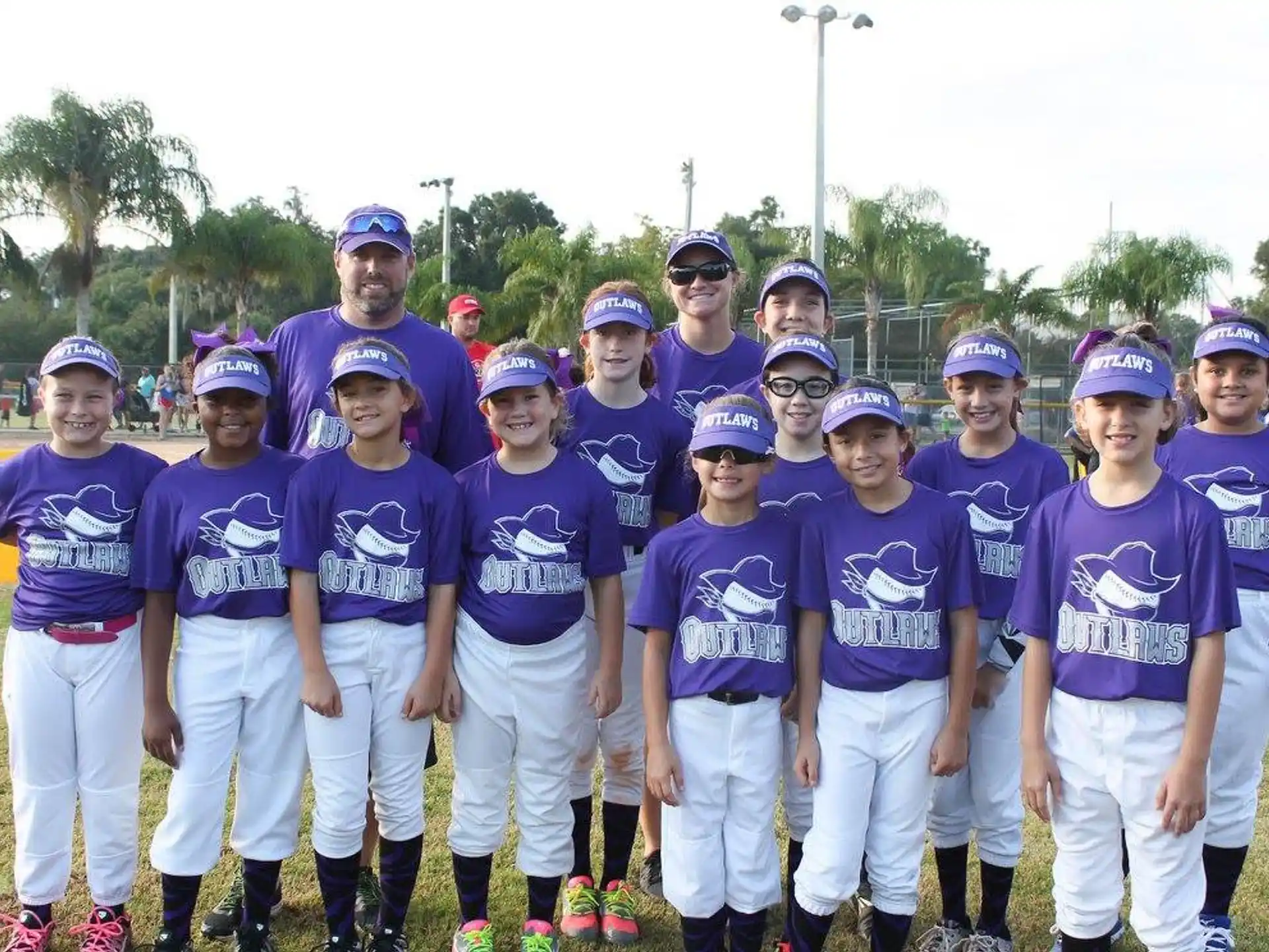 a group of people wearing purple shirts