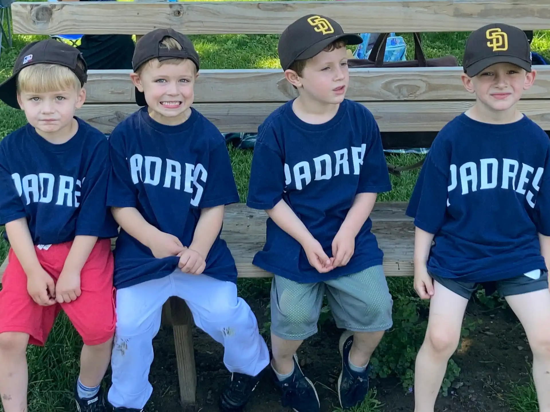 a group of boys sitting on a bench