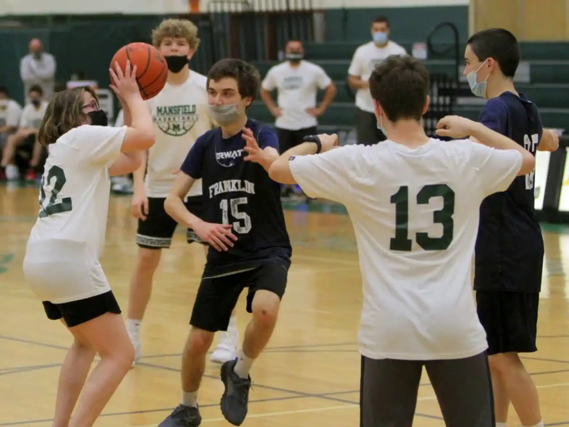 a group of people playing basketball