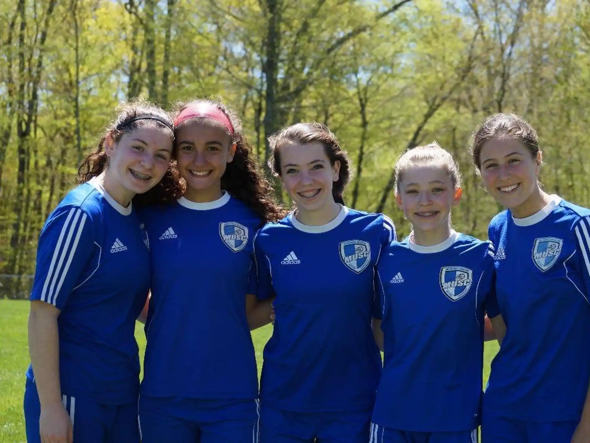 a group of people wearing blue shirts
