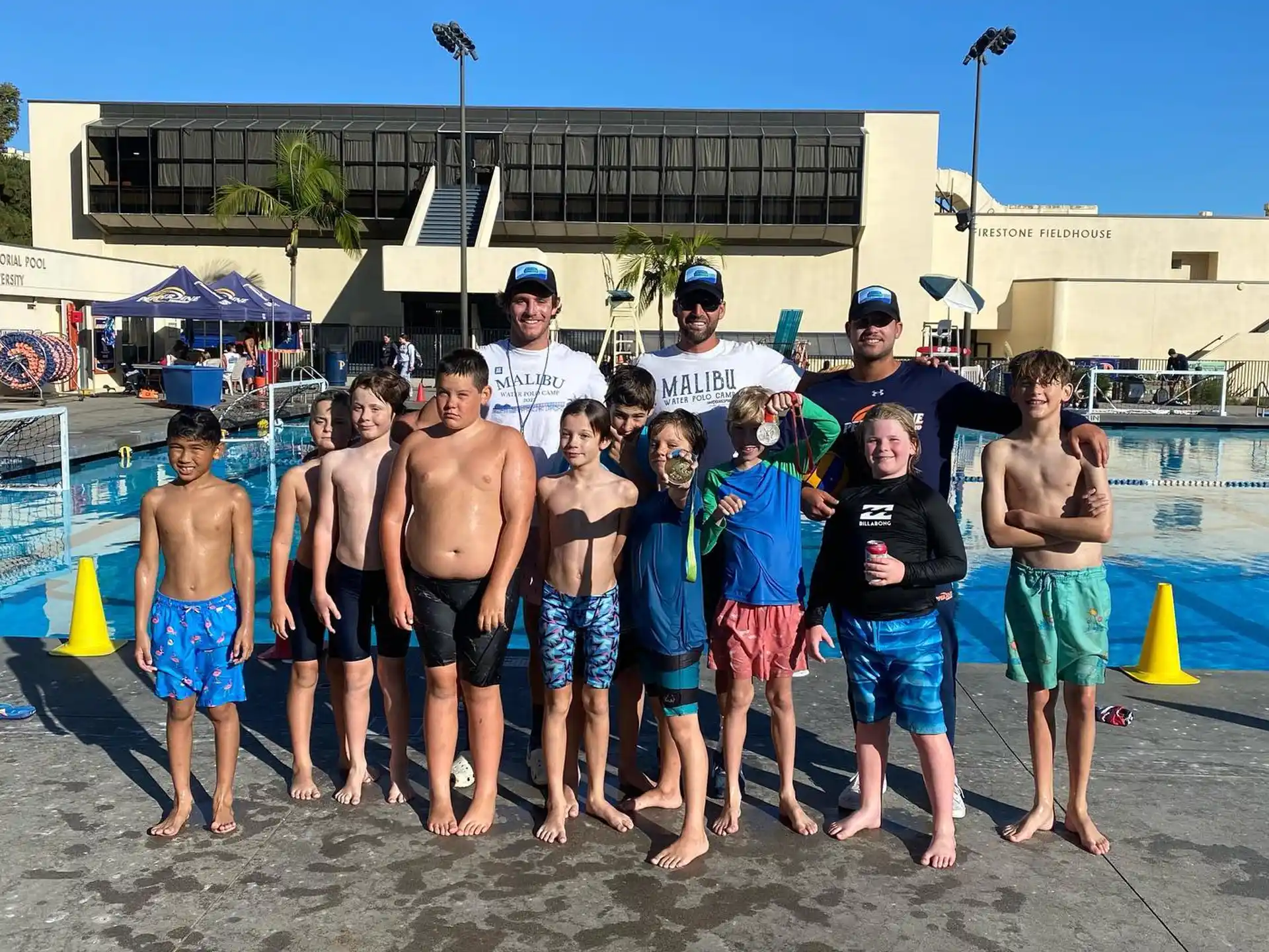 a group of men posing for a photo on a beach