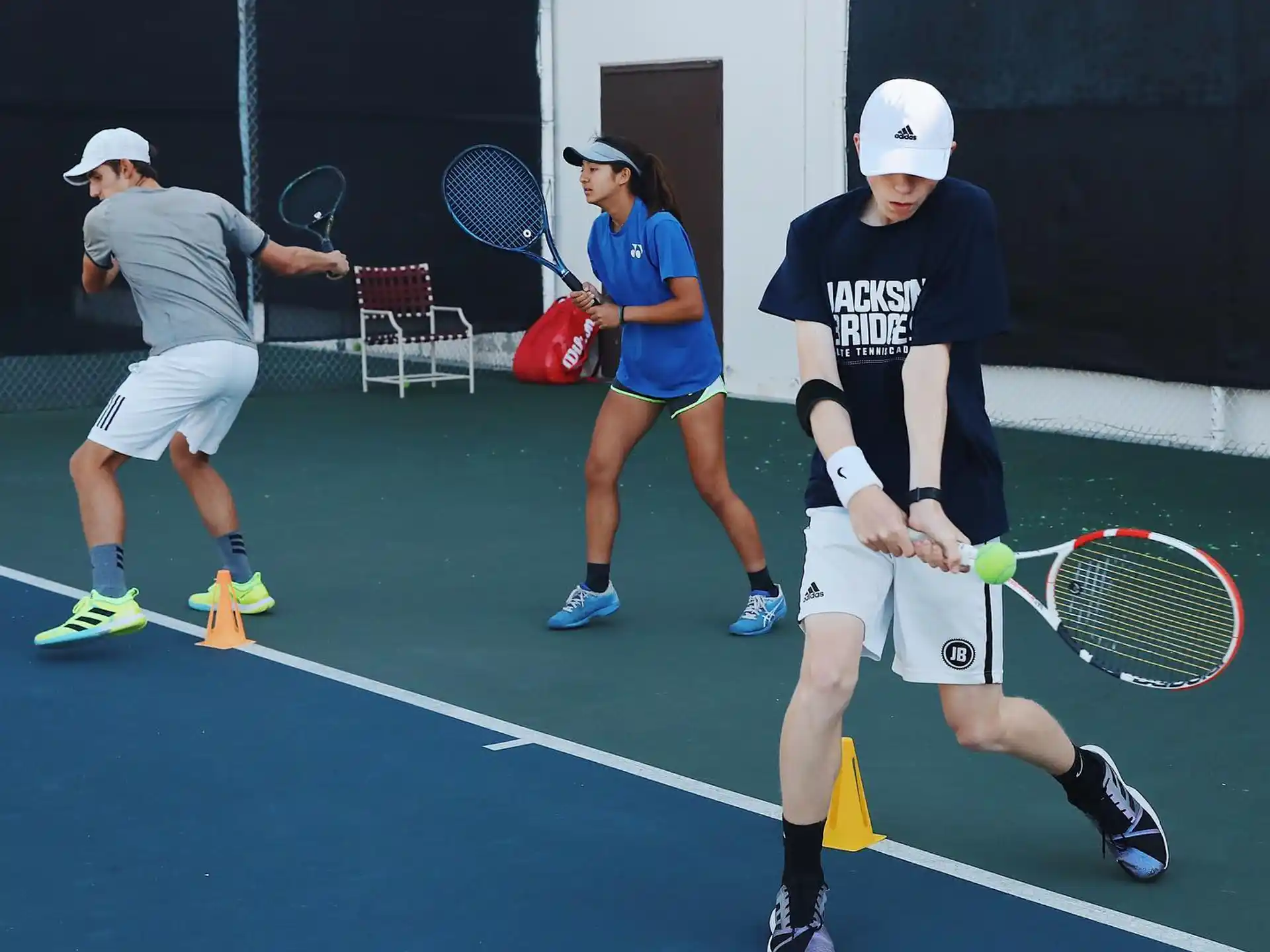 a group of people play tennis