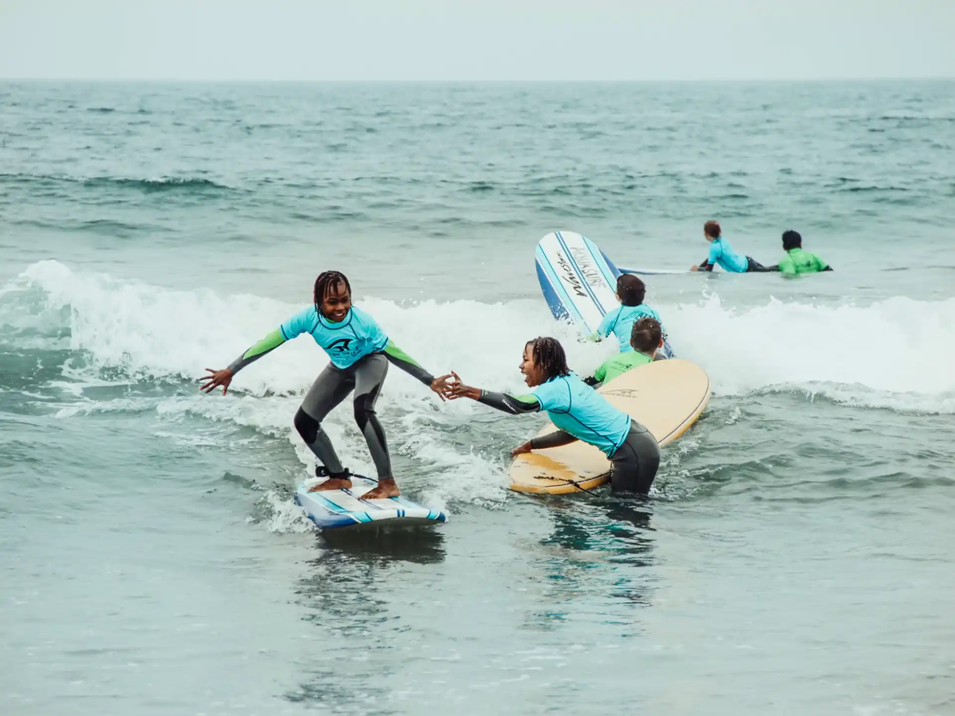 a group of people surfing in the sea
