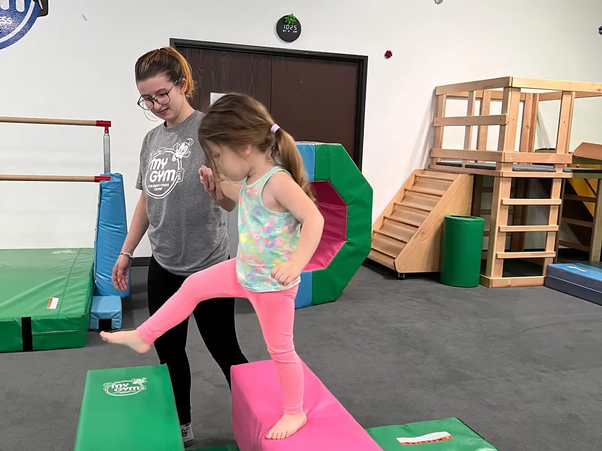 a person and a girl playing on a trampoline