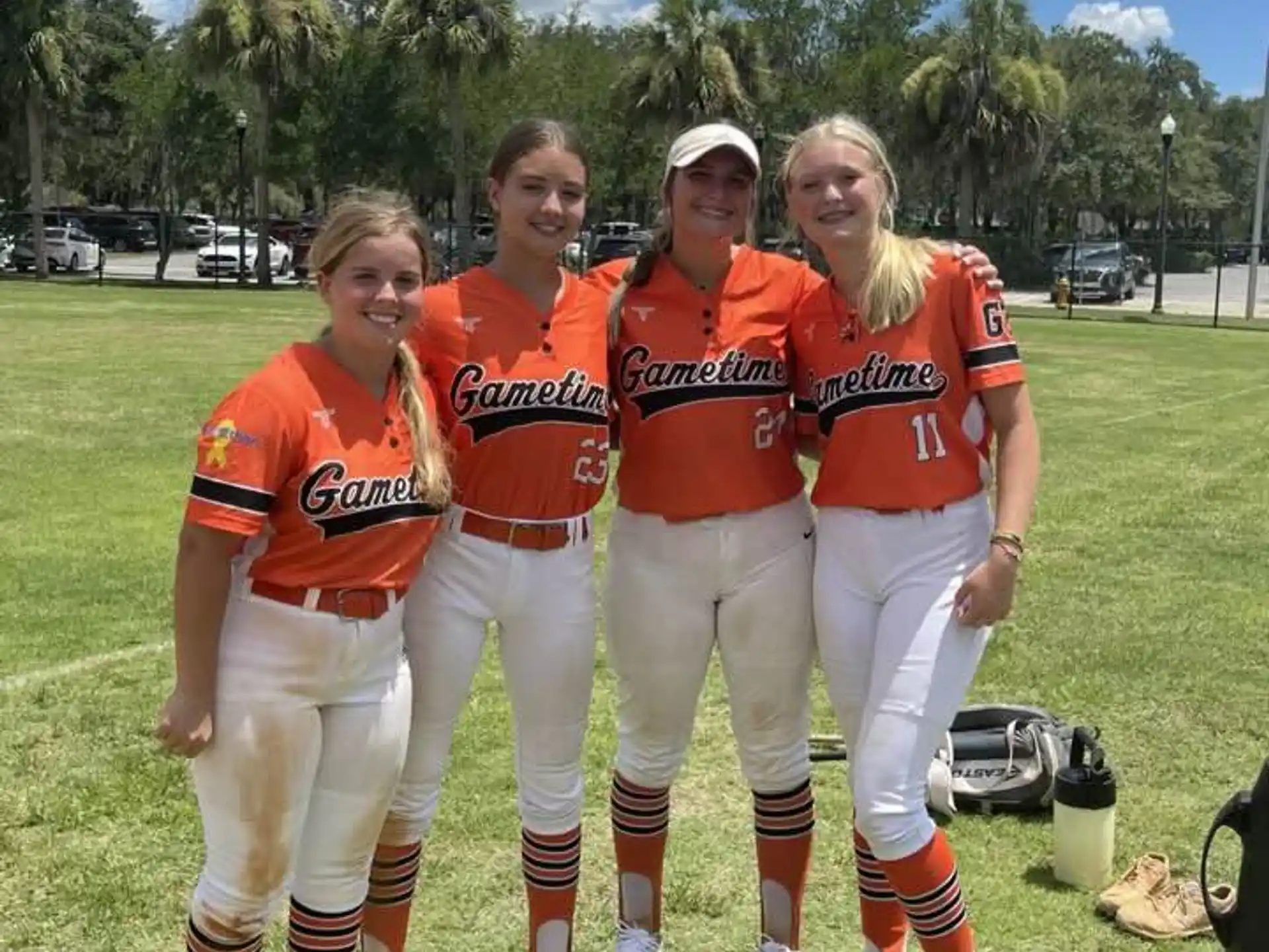 a group of women in orange shirts