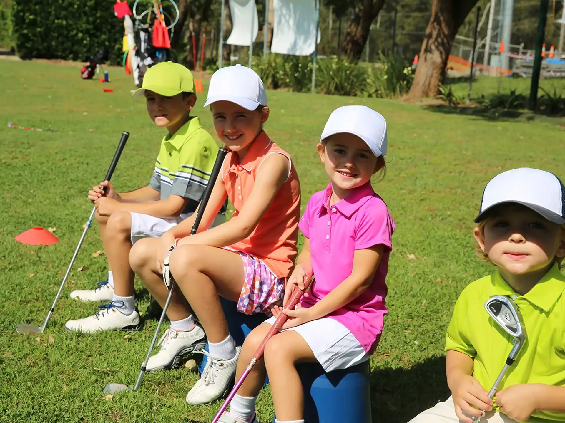 a group of kids sitting on a bench with crutches