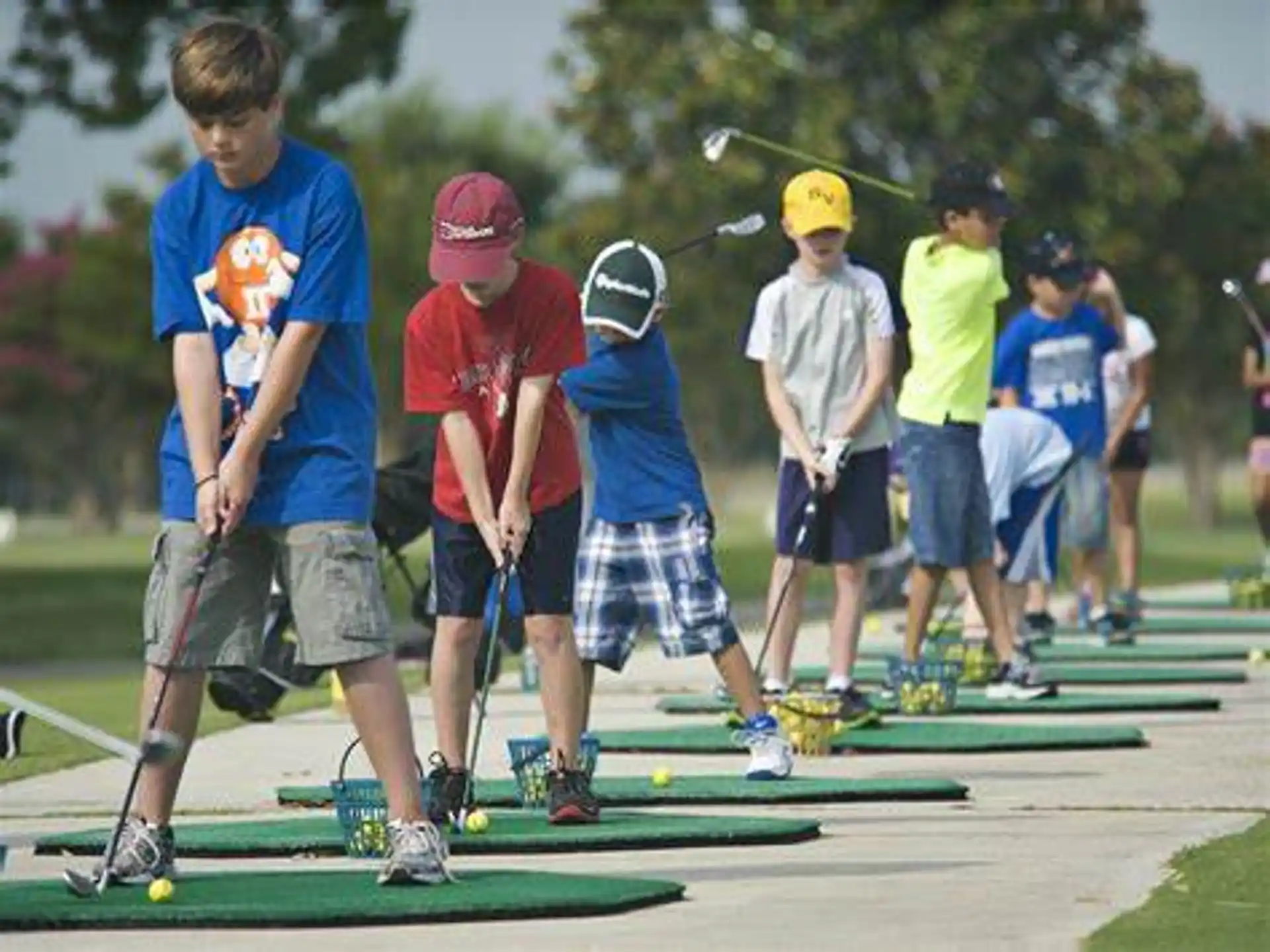 a group of kids playing mini golf