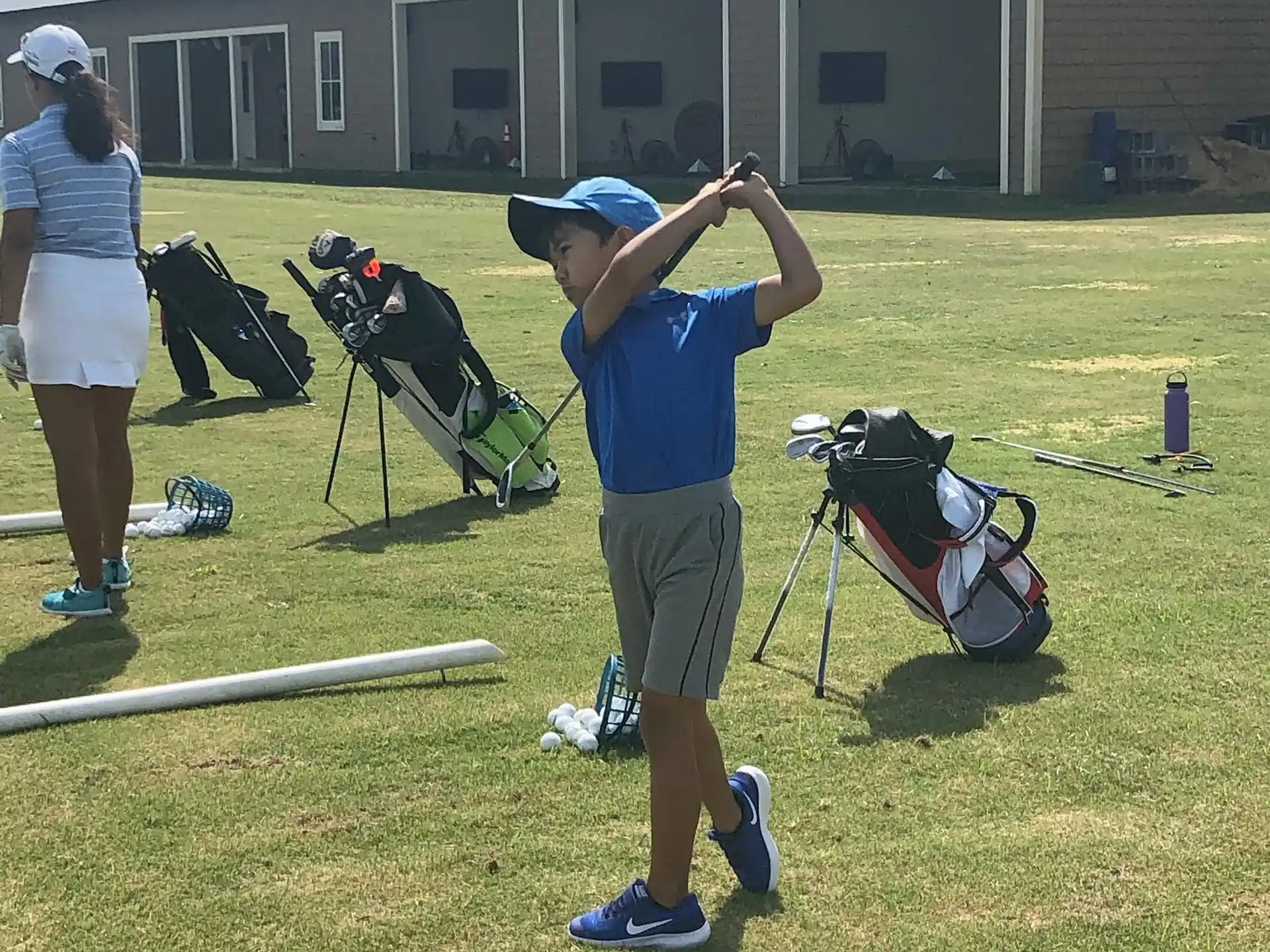 a person swinging a golf club