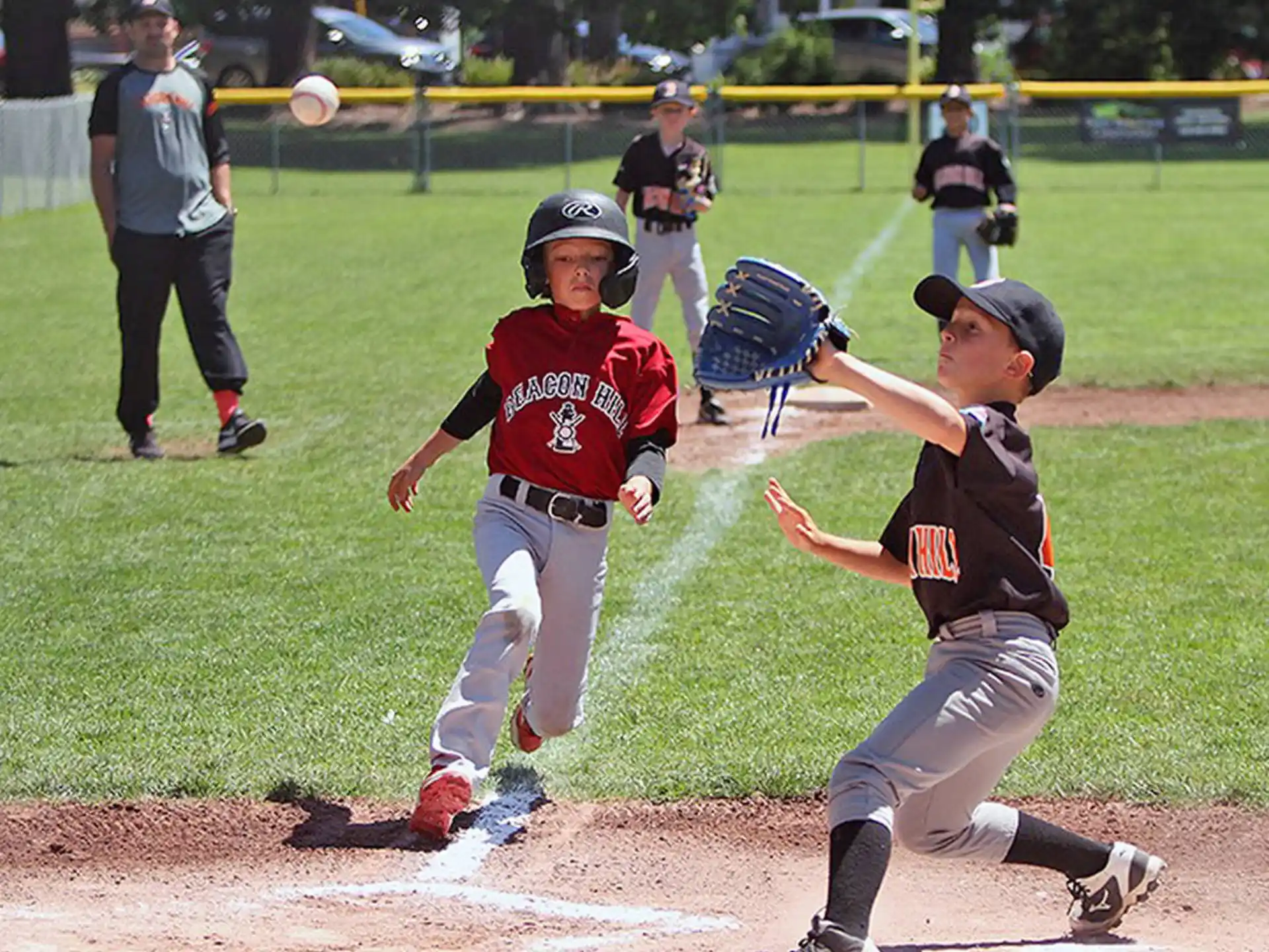 kids playing baseball on a field