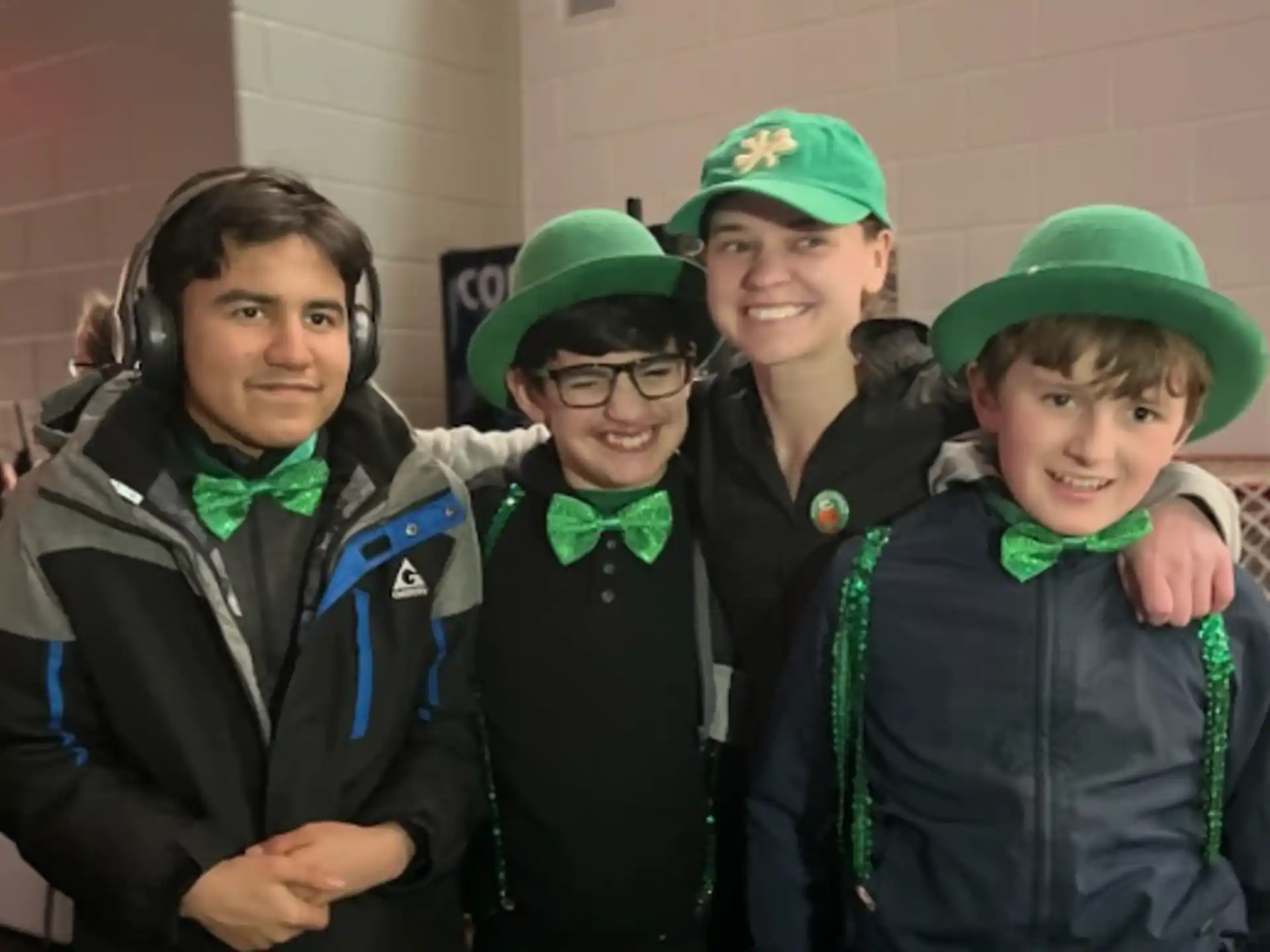 a group of people wearing green hats