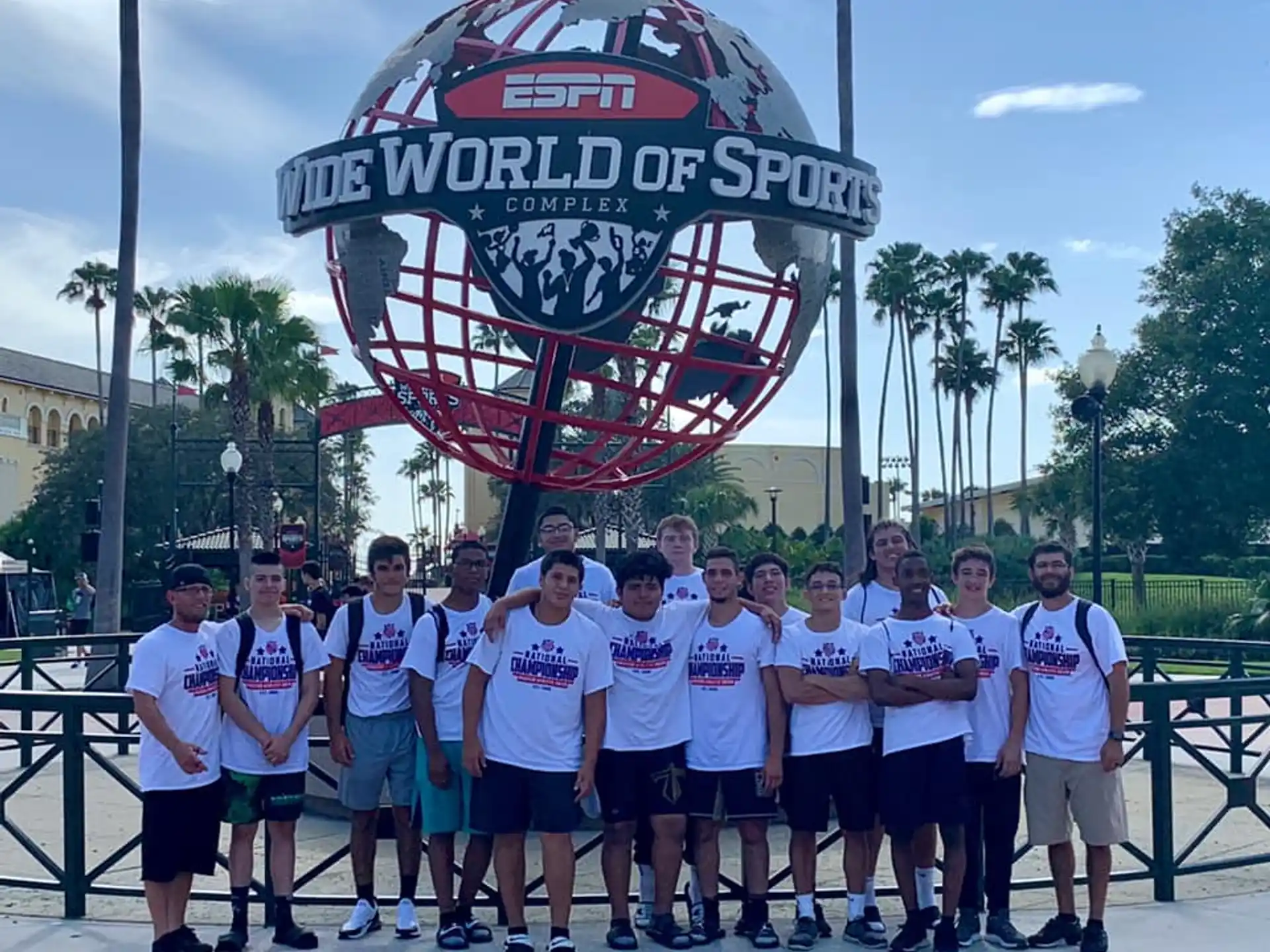 a group of people posing for a photo in front of a sign