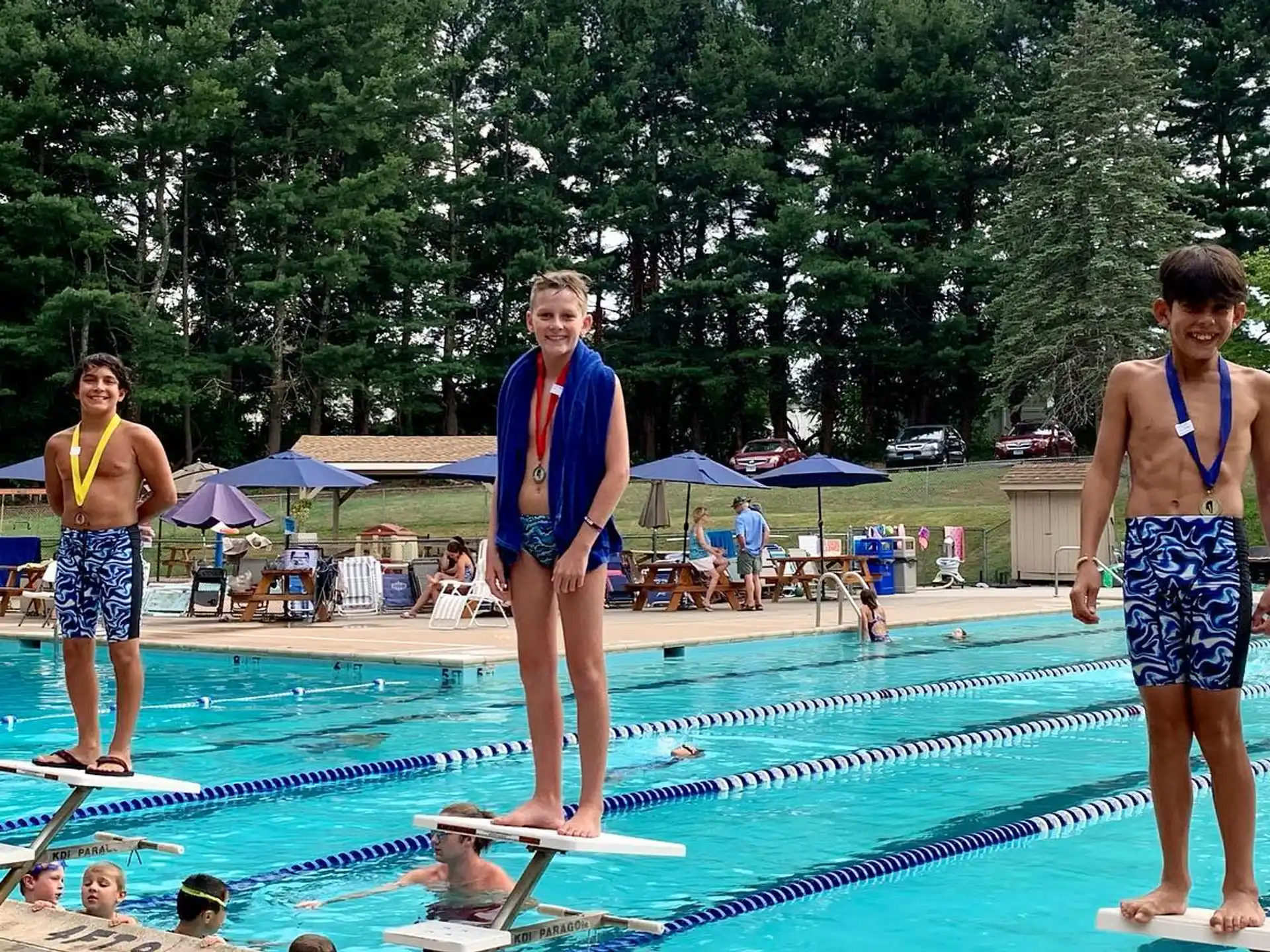 a group of people standing by a pool