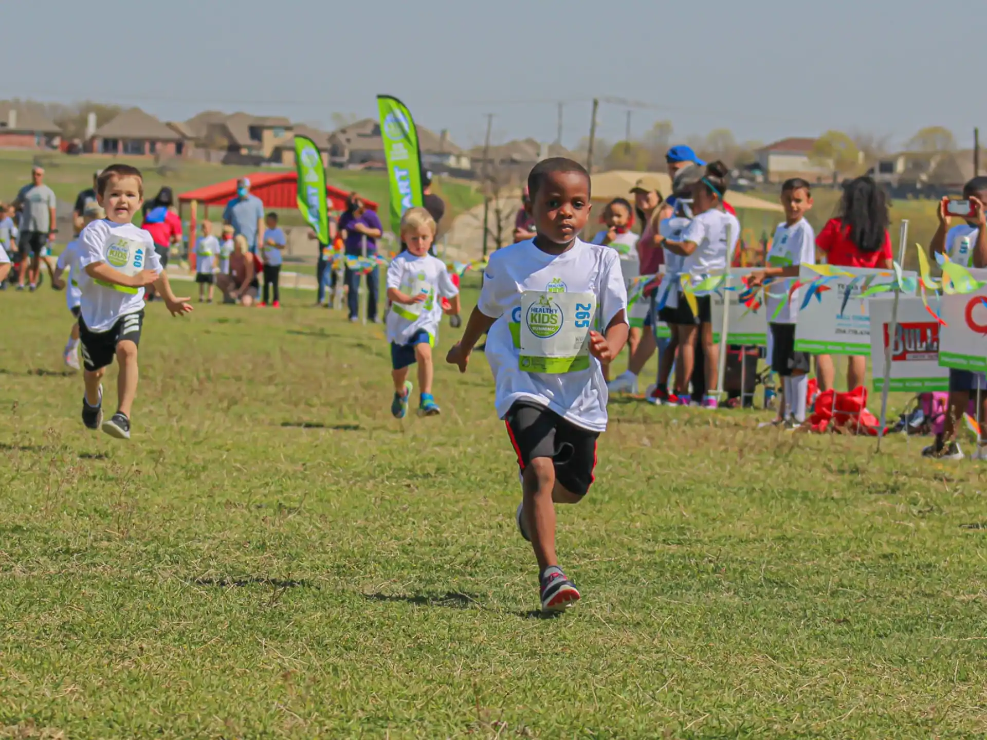 a group of children running on a field