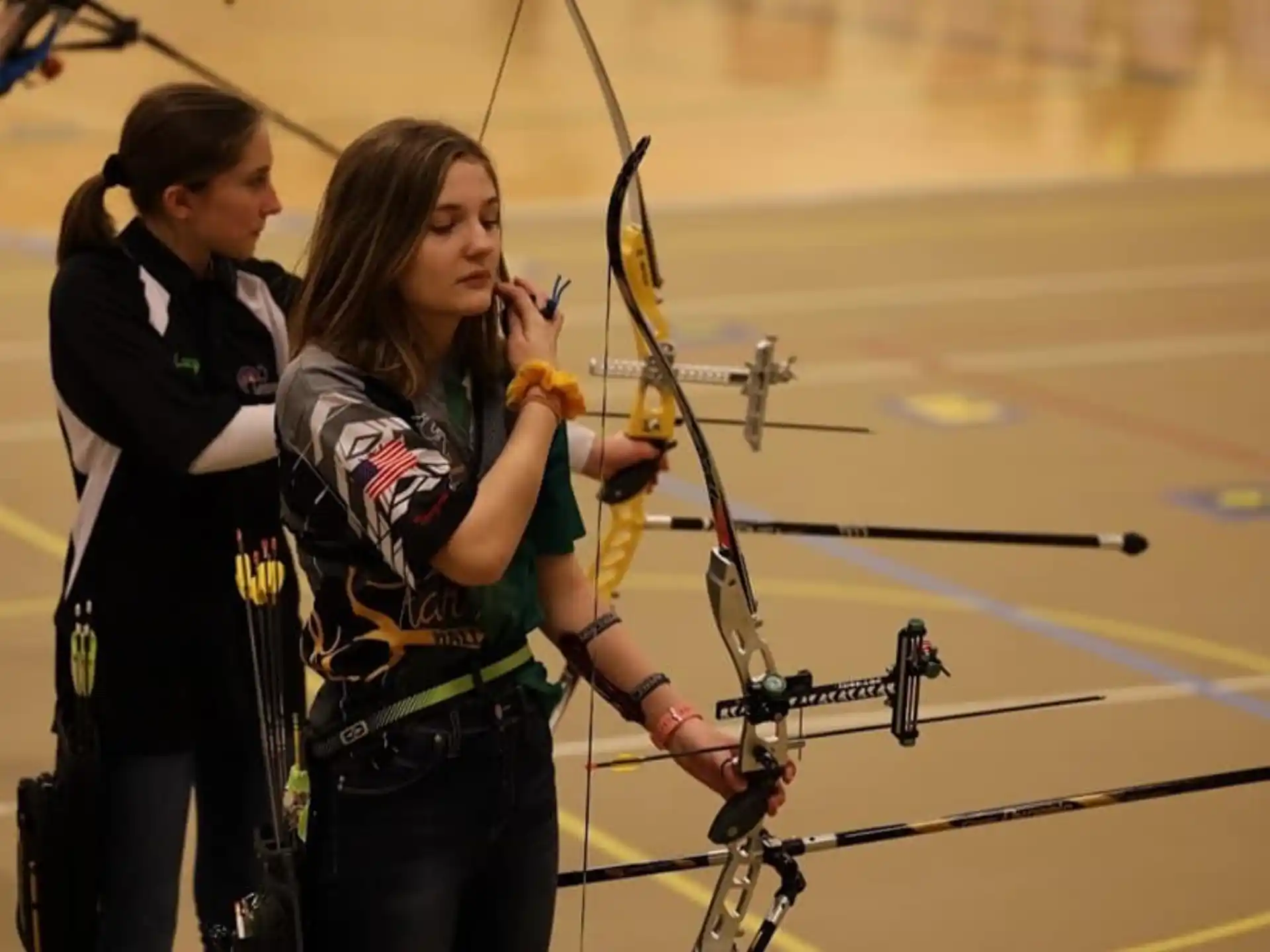 a couple of women shooting bows