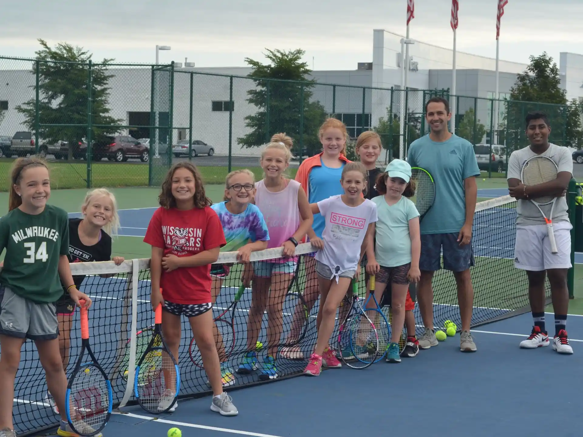 a group of people holding tennis rackets