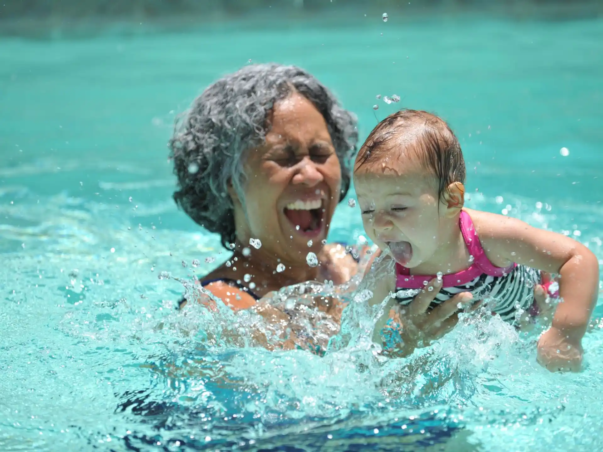 a man and a baby in a pool