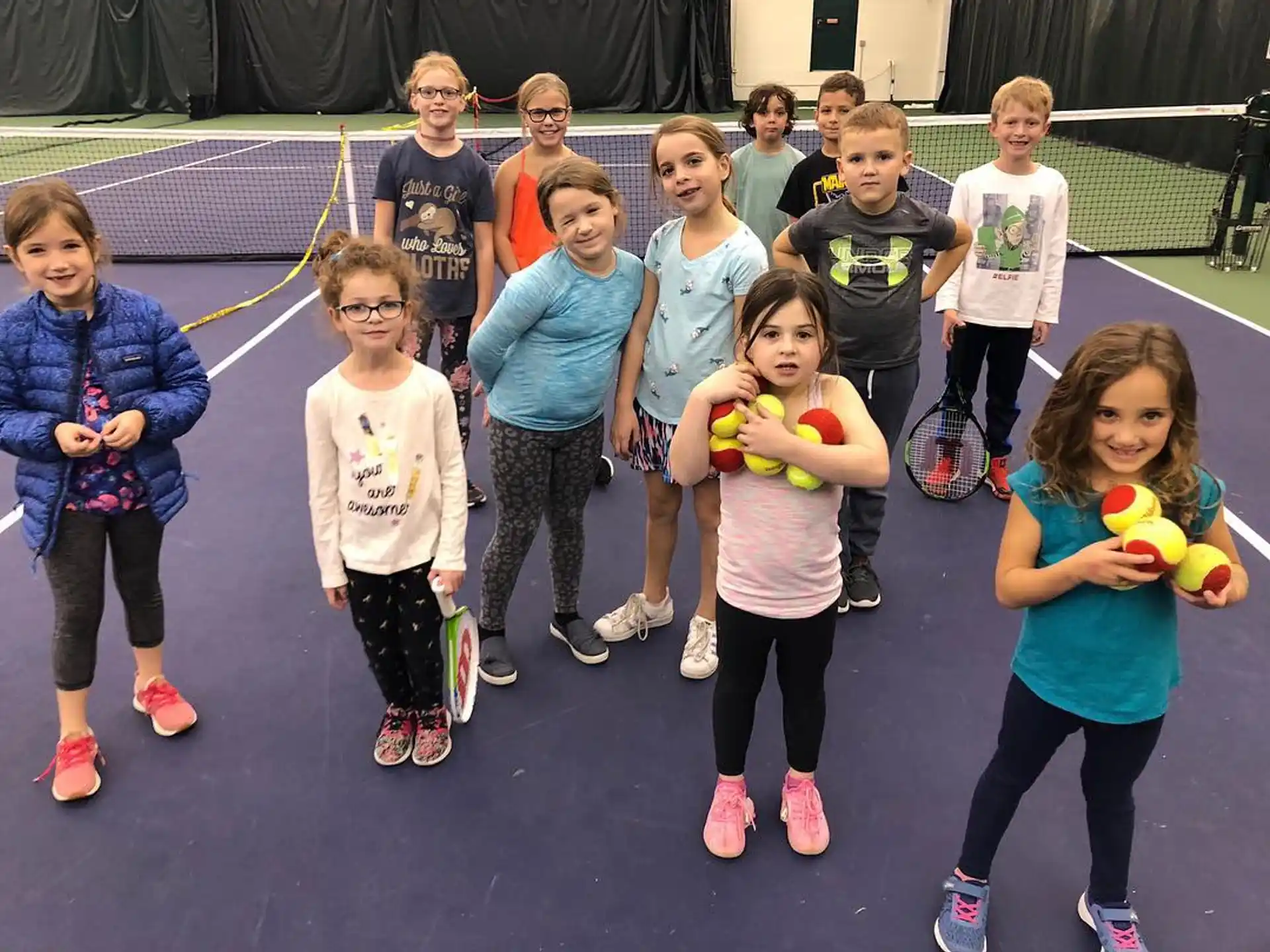 a group of children holding balls