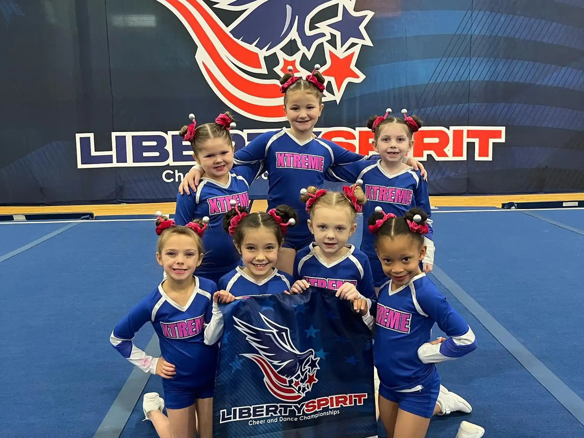 a group of girls in blue uniforms