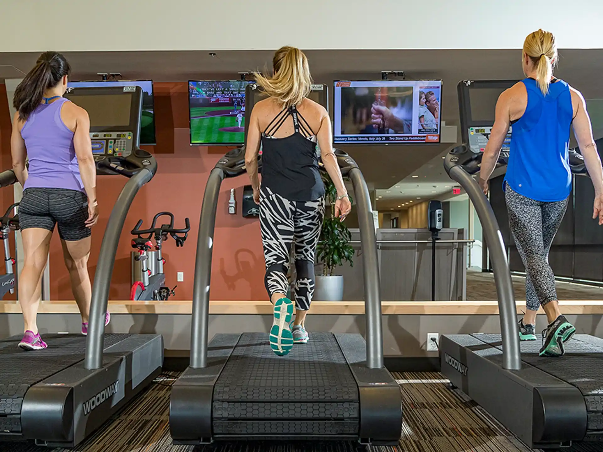 a group of women exercising in a gym