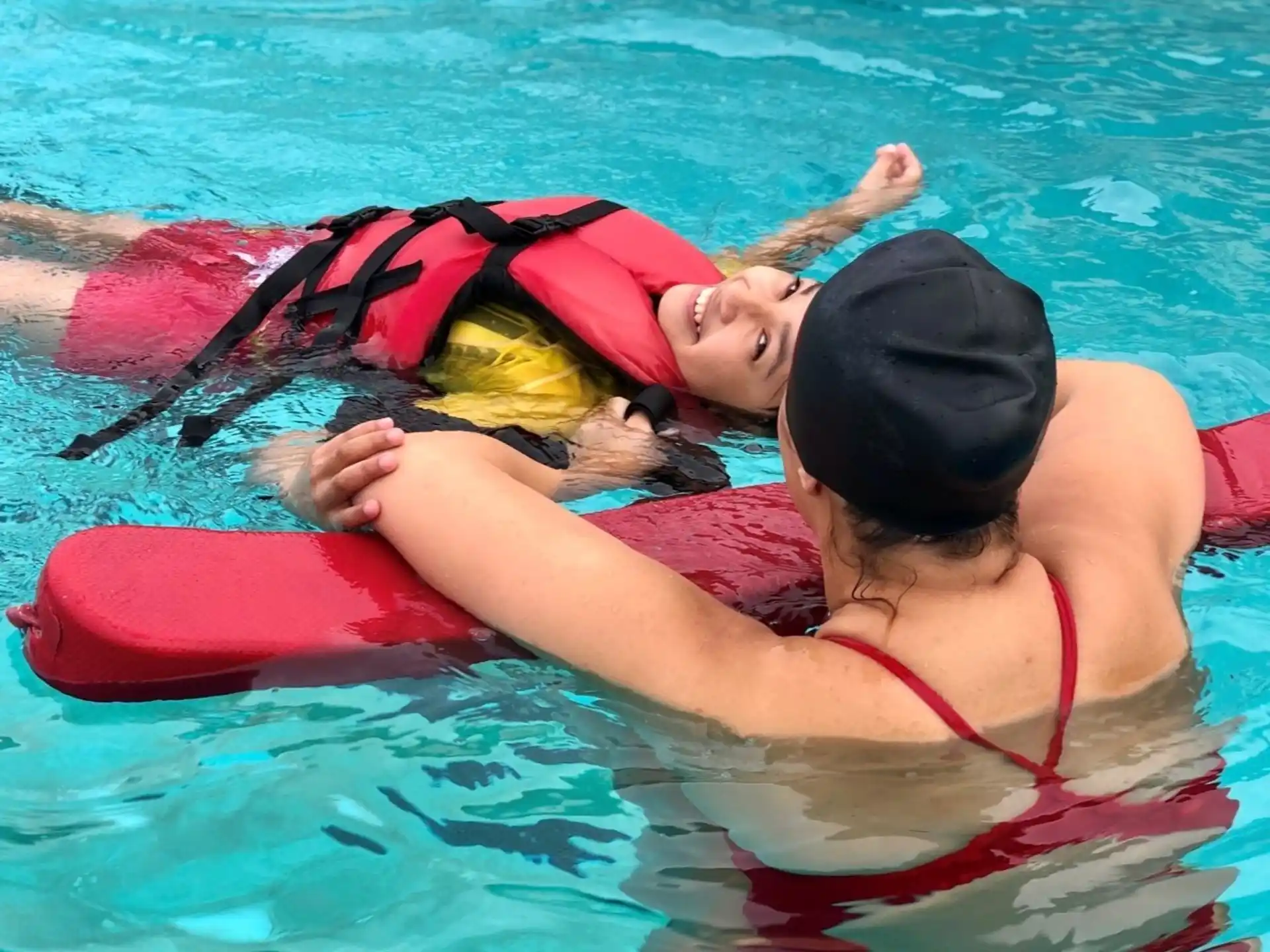 a person and a baby in a pool