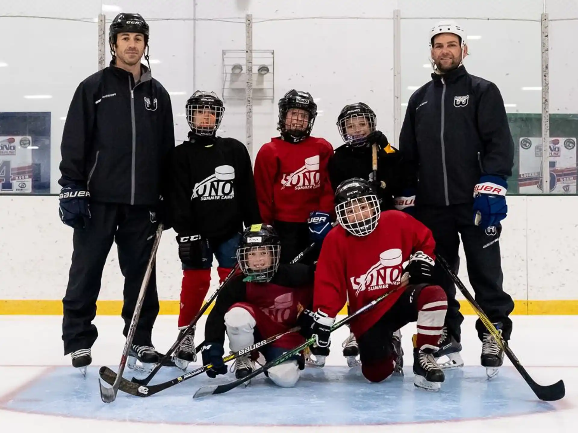 a group of hockey players posing for a photo