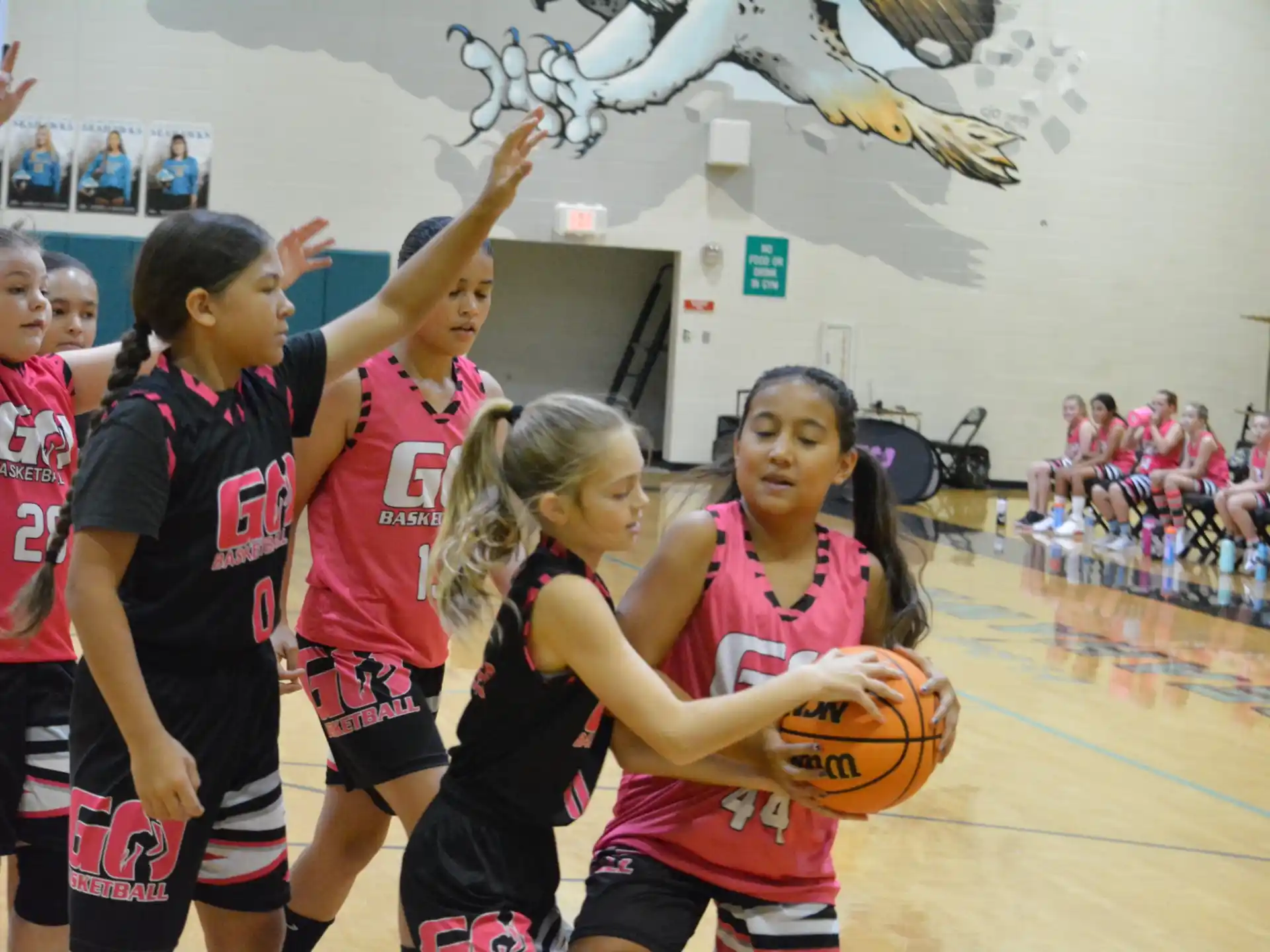 a group of girls playing basketball