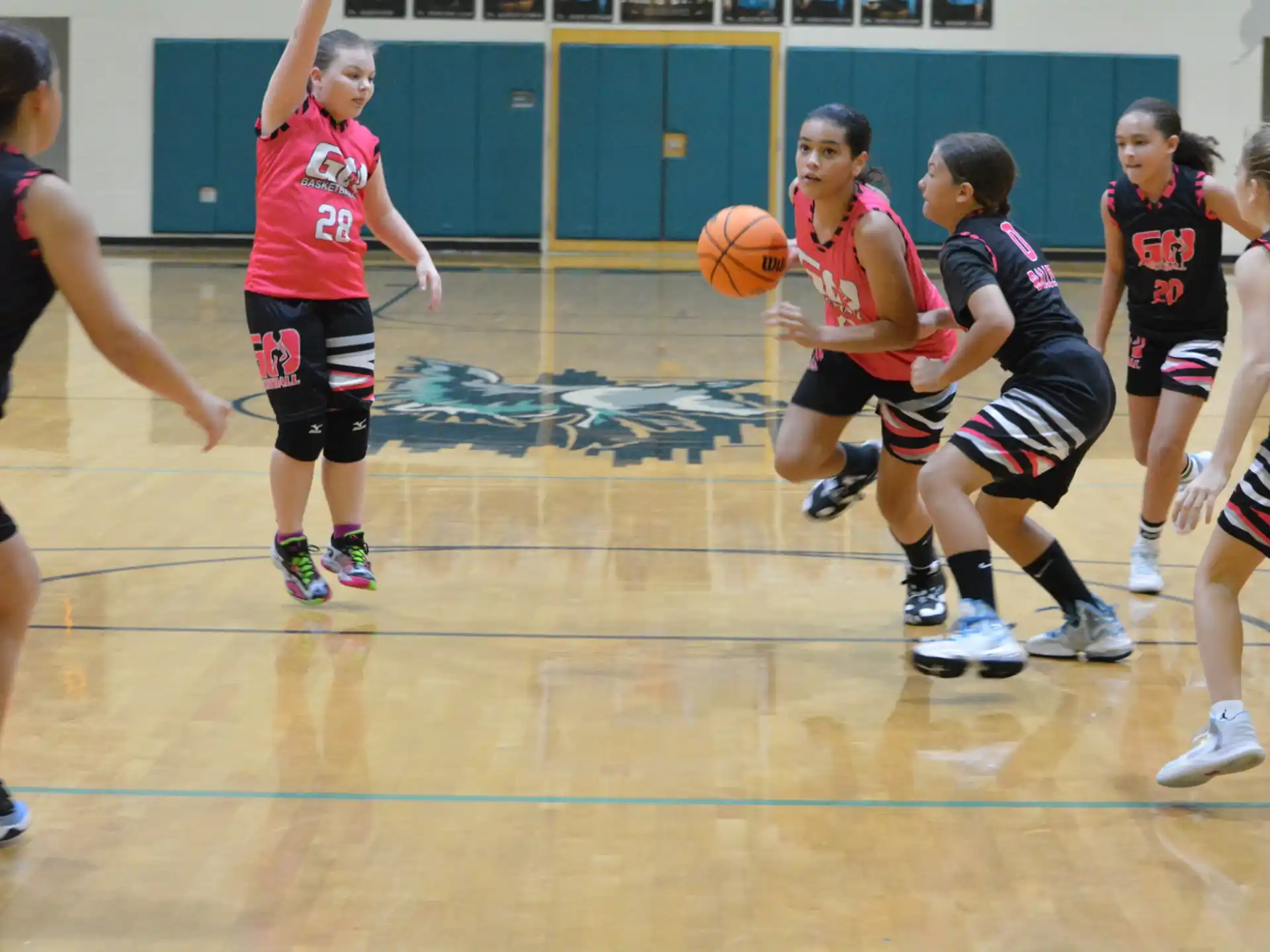a group of girls playing basketball