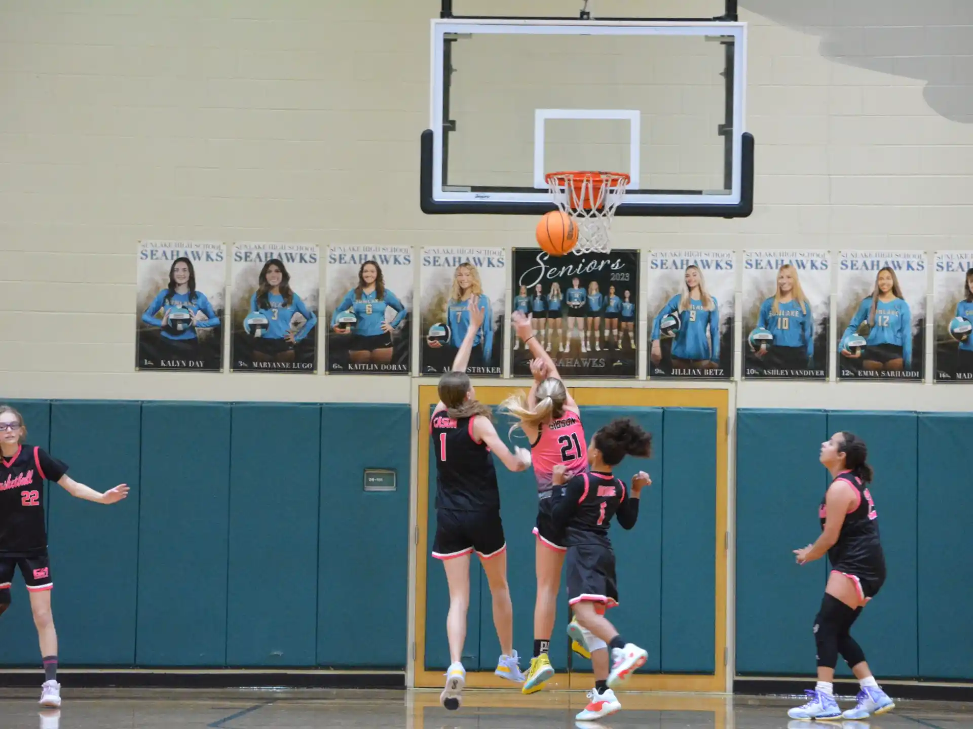 a group of women playing basketball