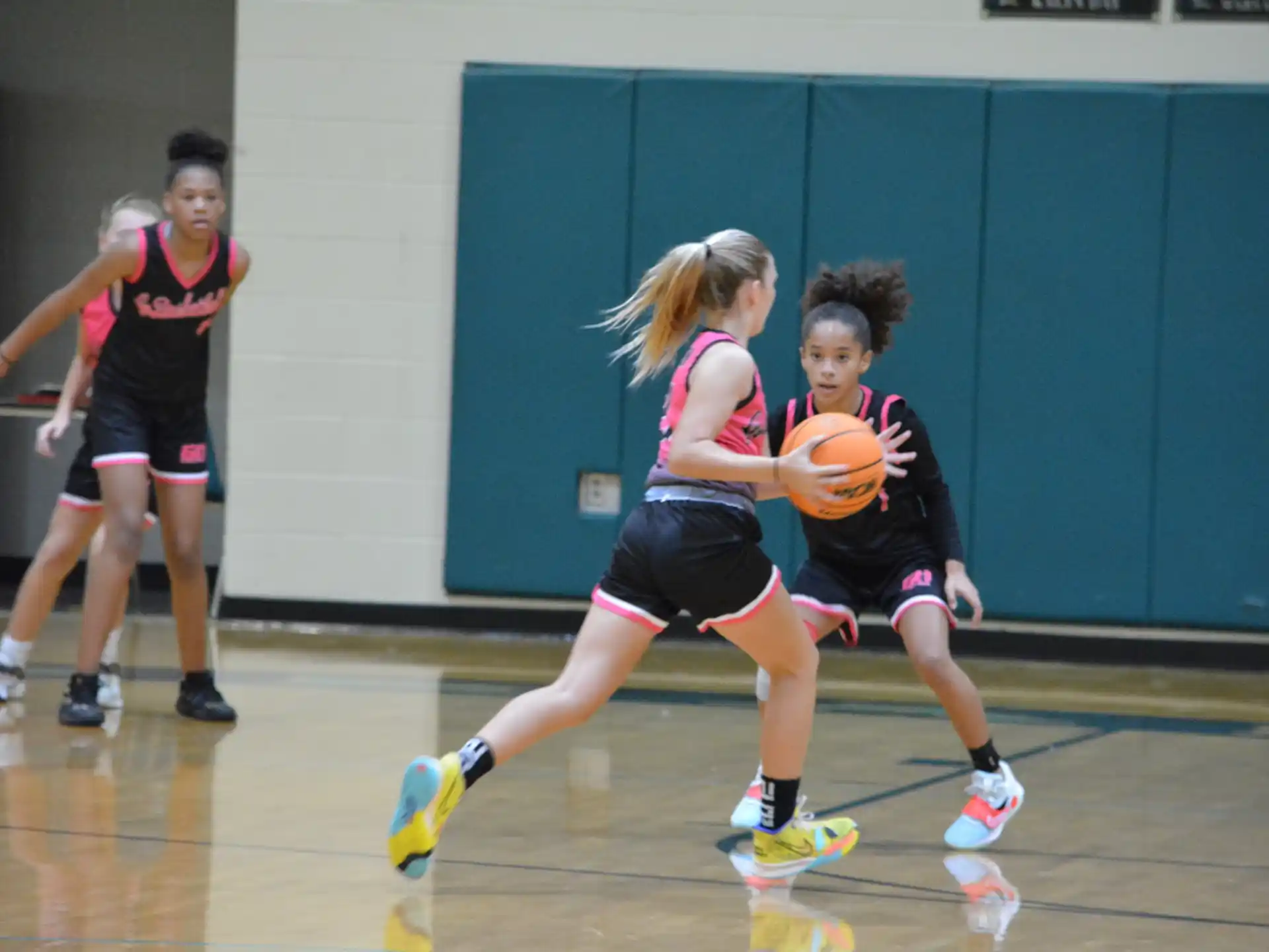 a group of women playing basketball