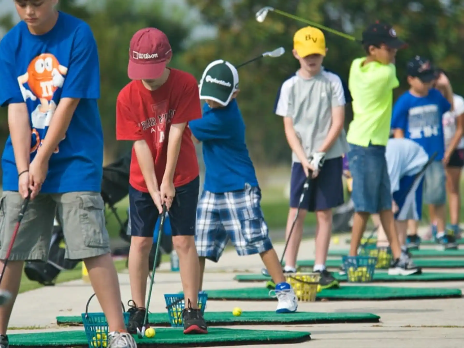 a group of kids playing golf