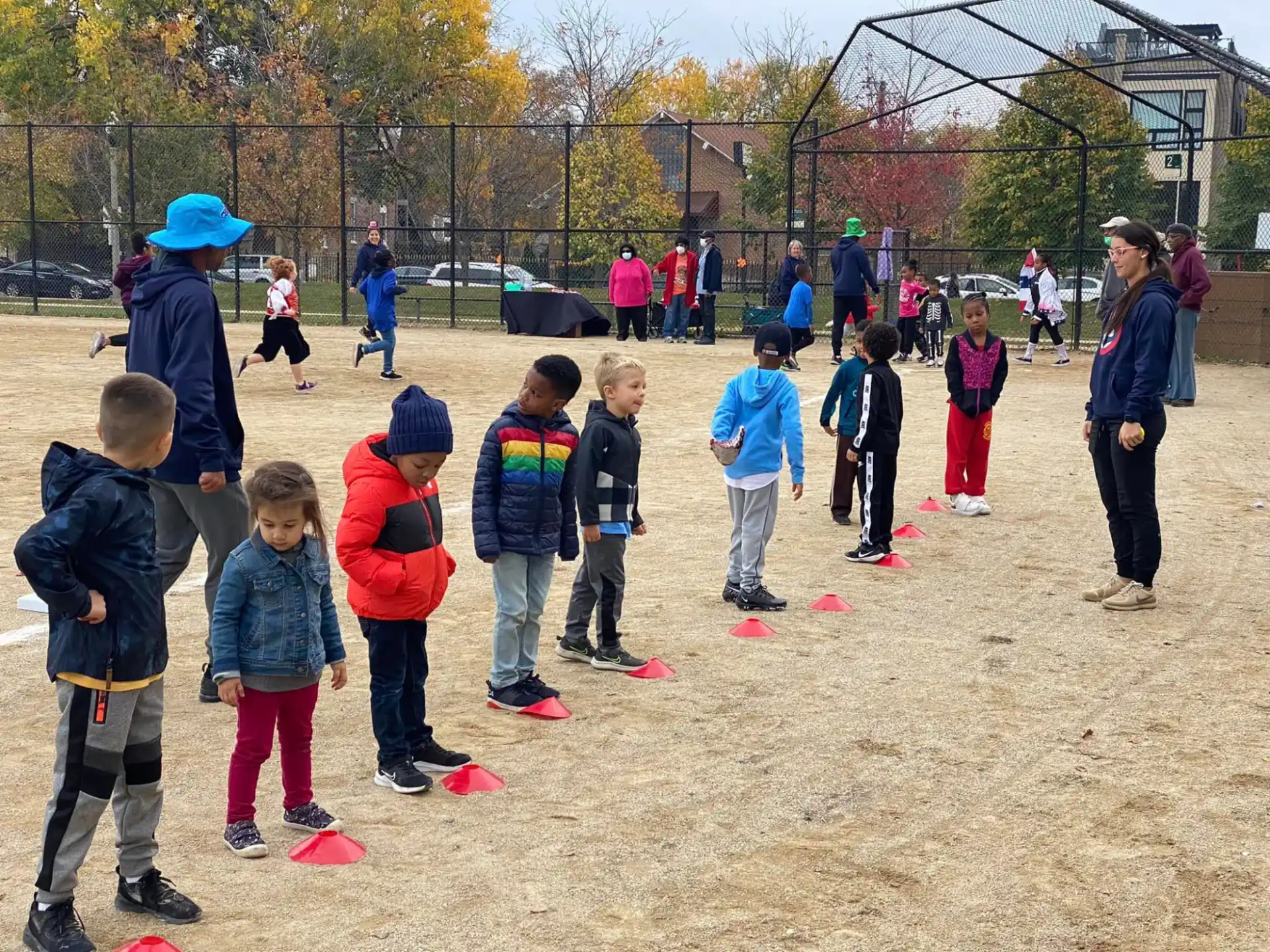 a group of children playing in a dirt field