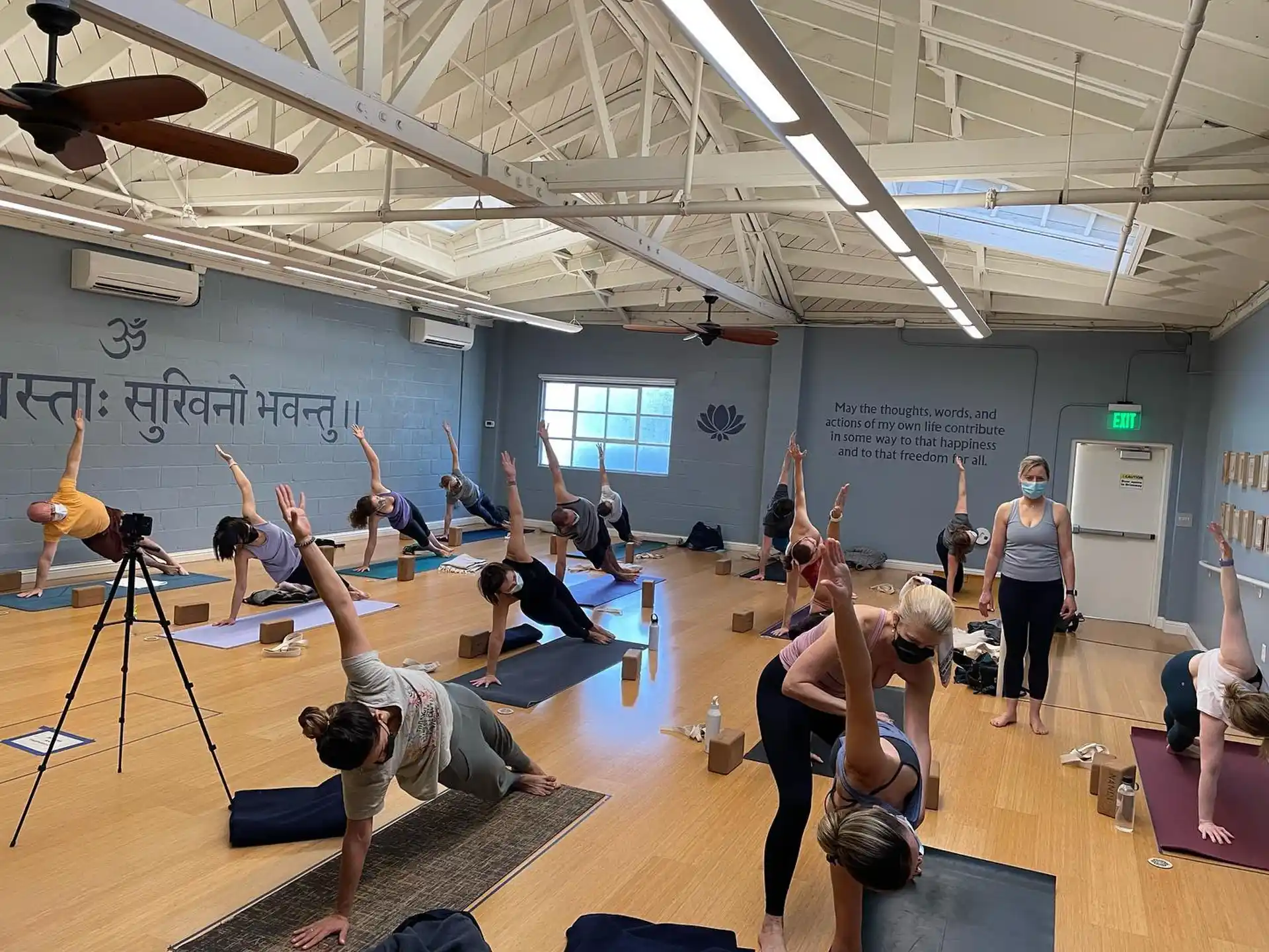 a group of people exercising in a gym