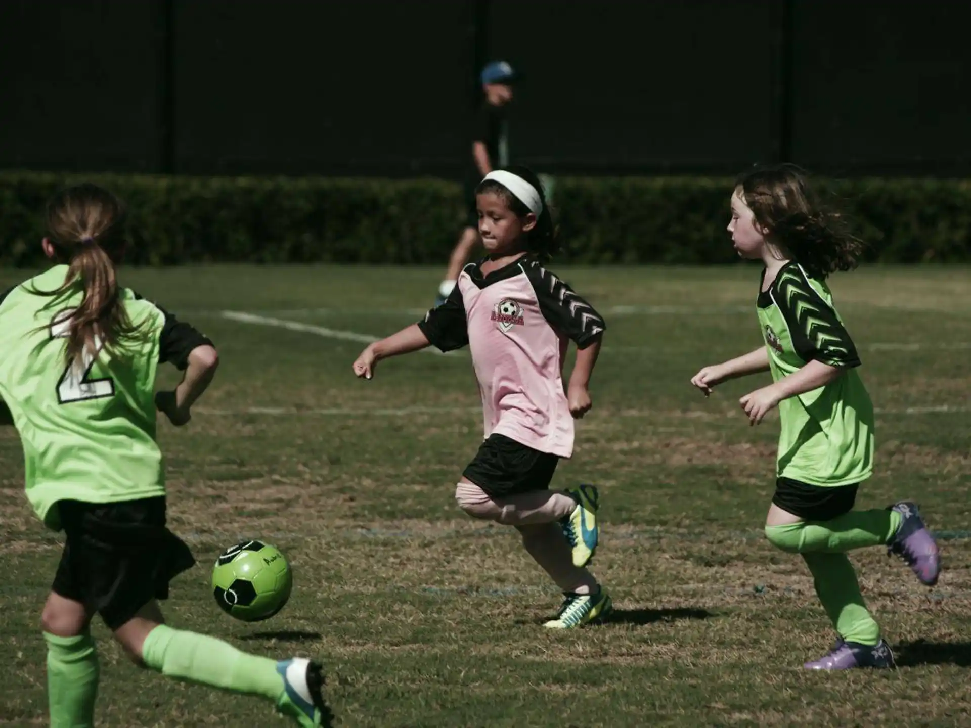 girls playing football on a field