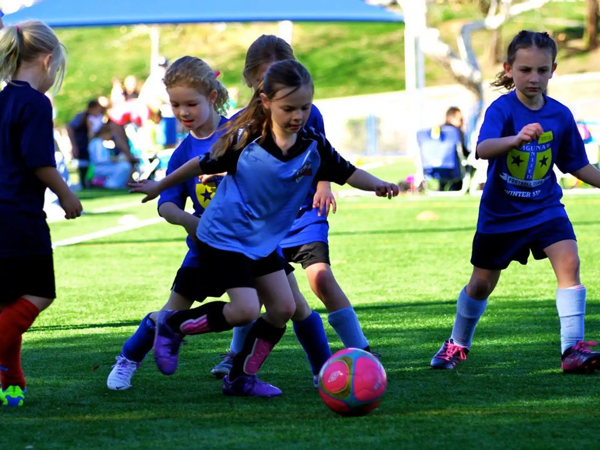 girls playing football on a field