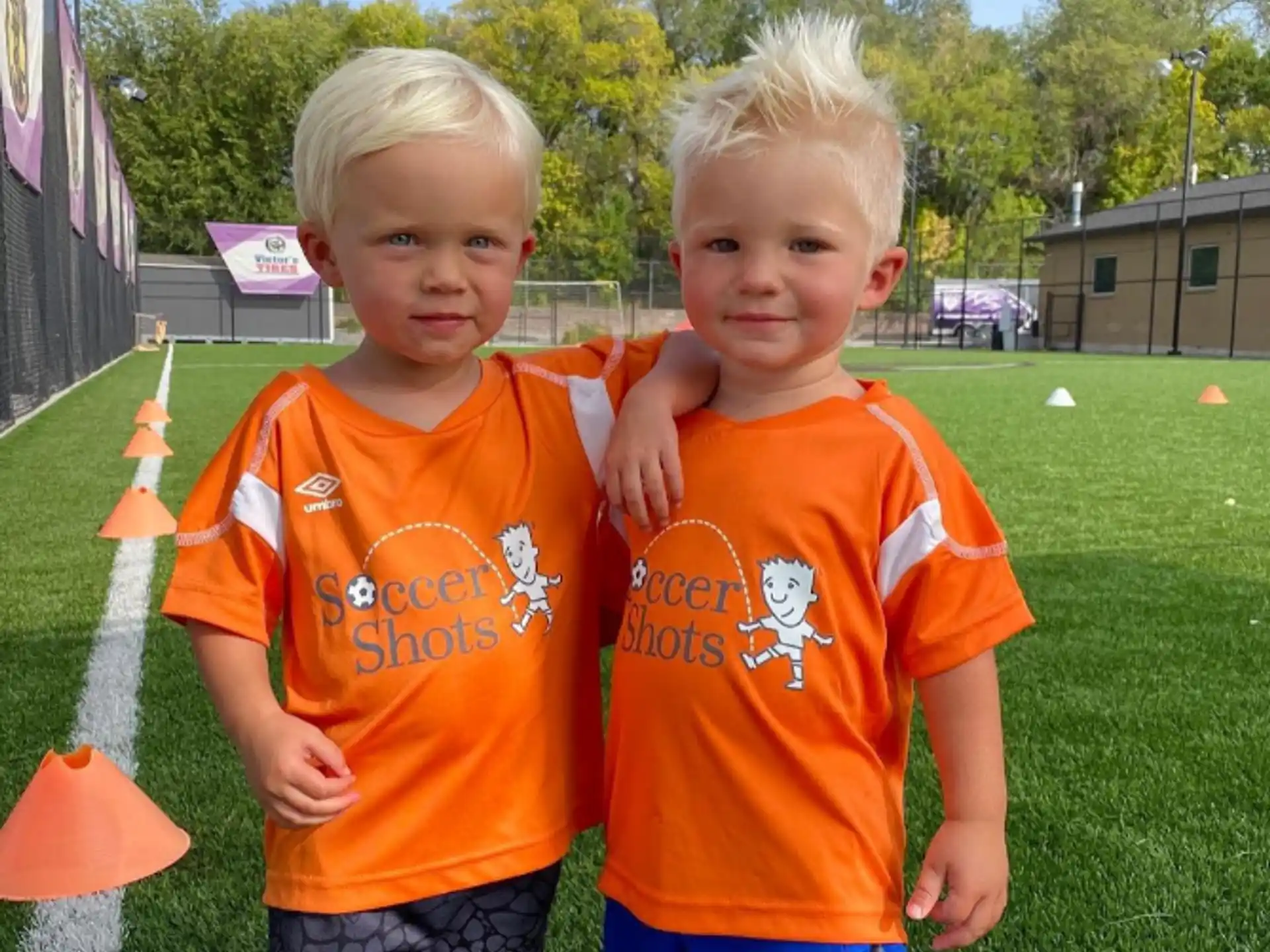 two boys in orange shirts