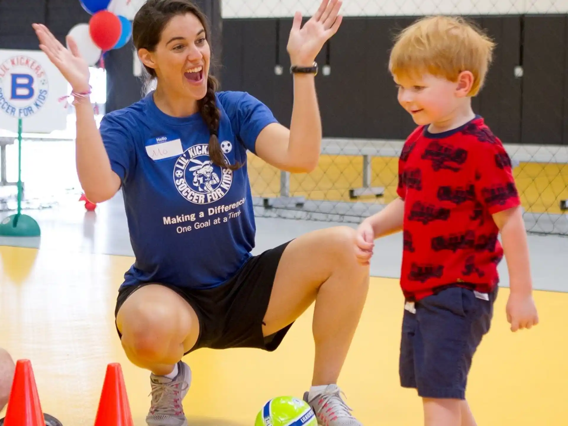 a person and a child playing with a ball
