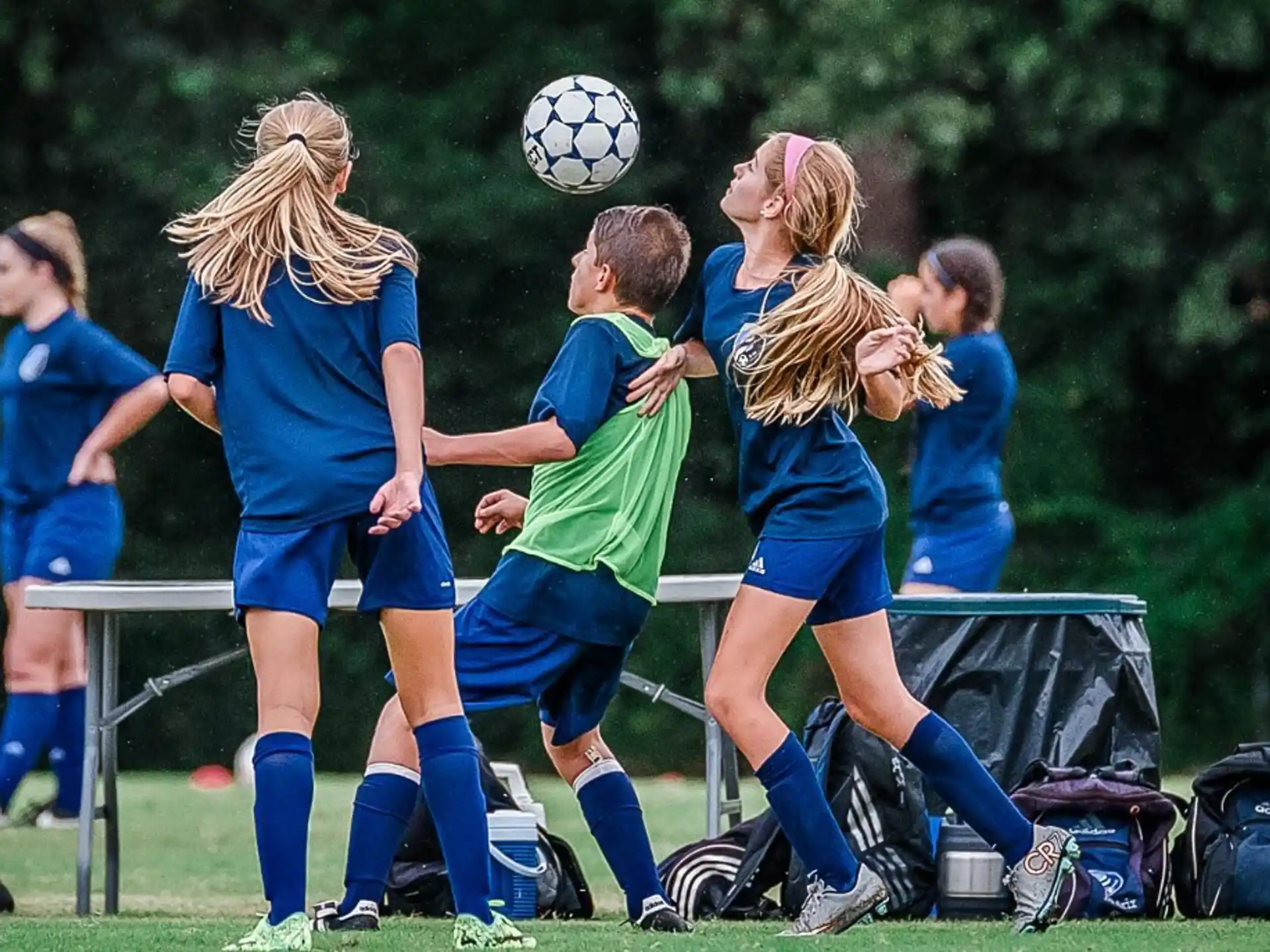 girls playing football on a field