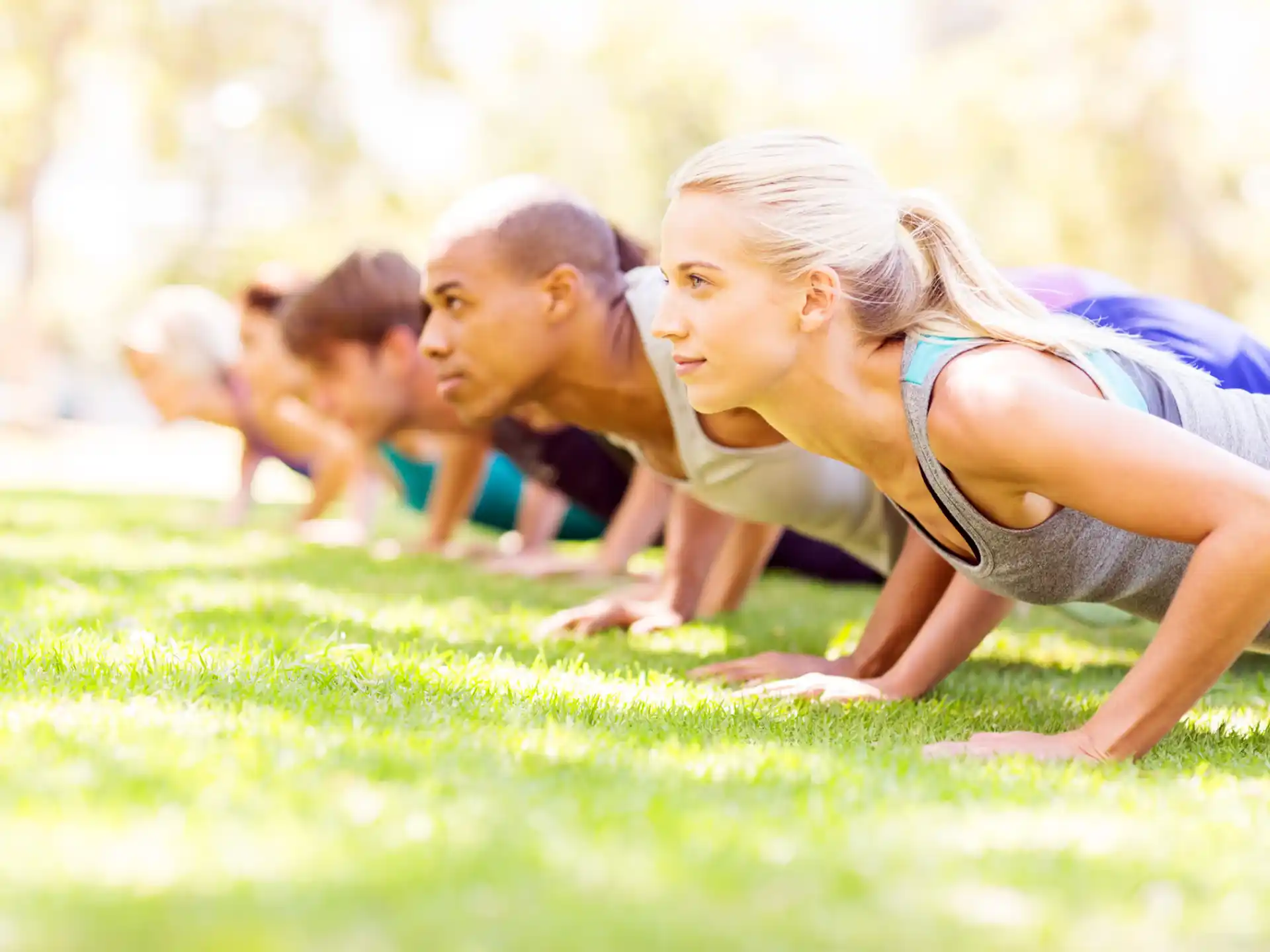 a group of people lying on the grass