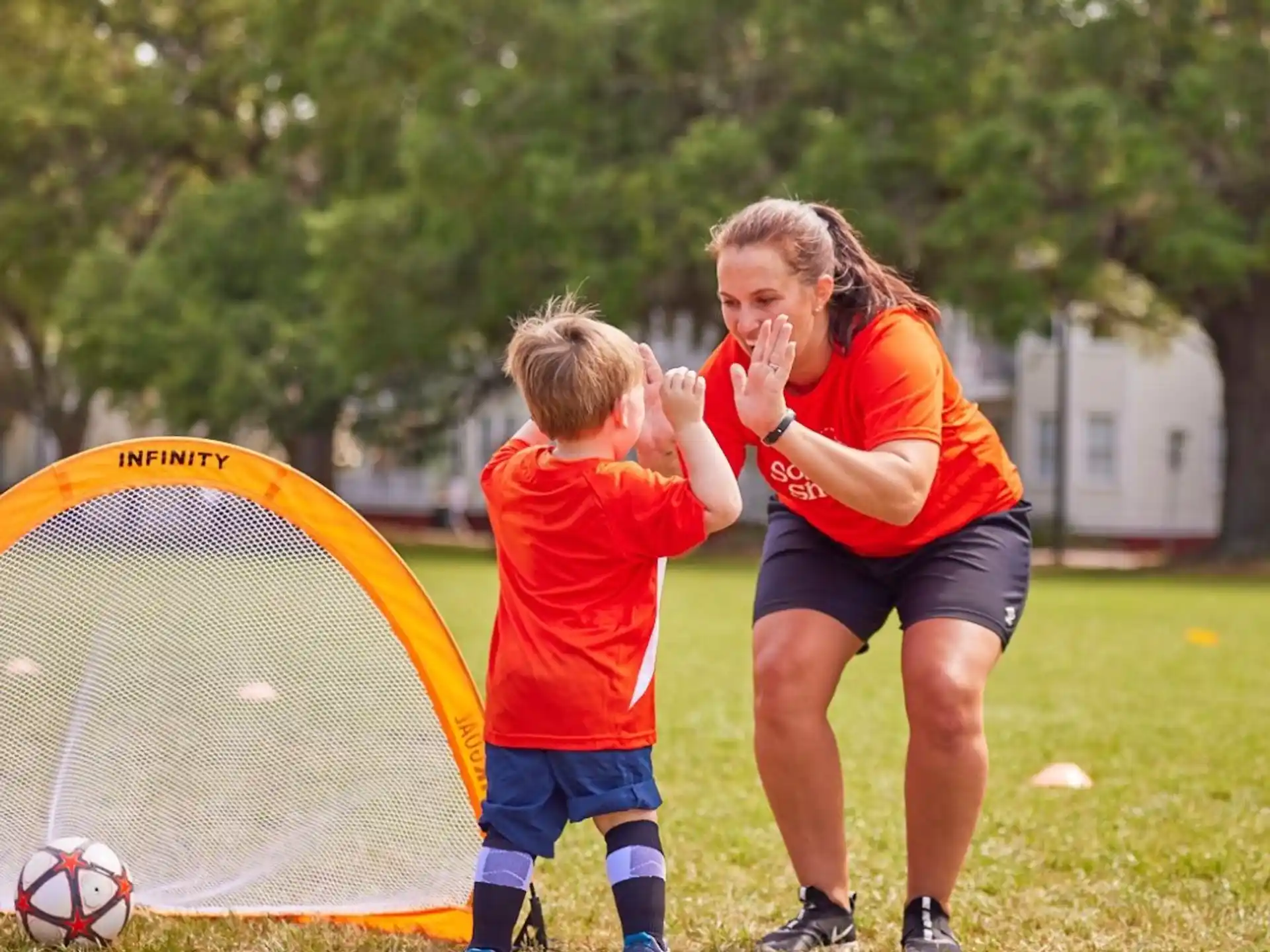 a woman and a child playing football