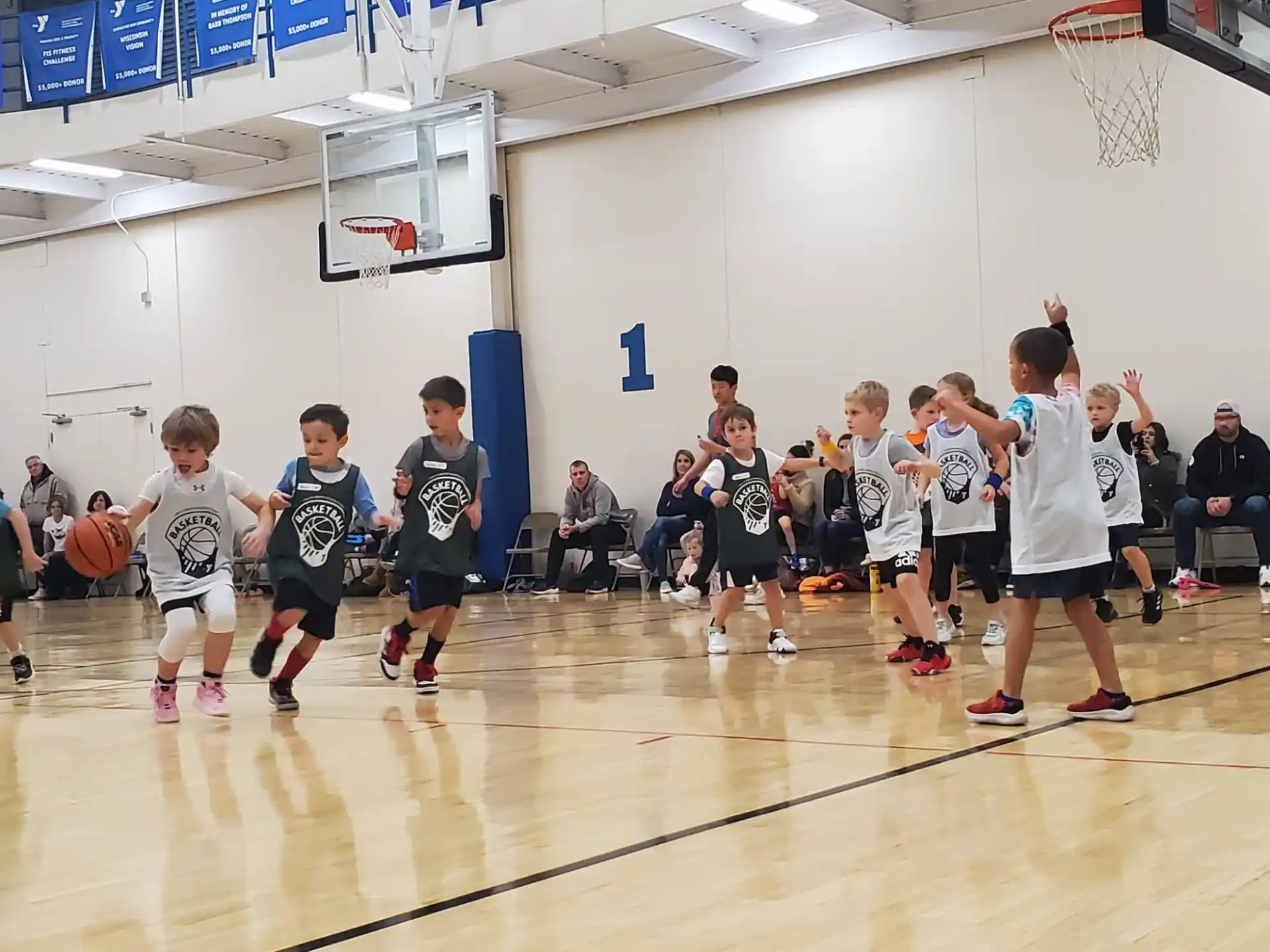 a group of kids playing basketball