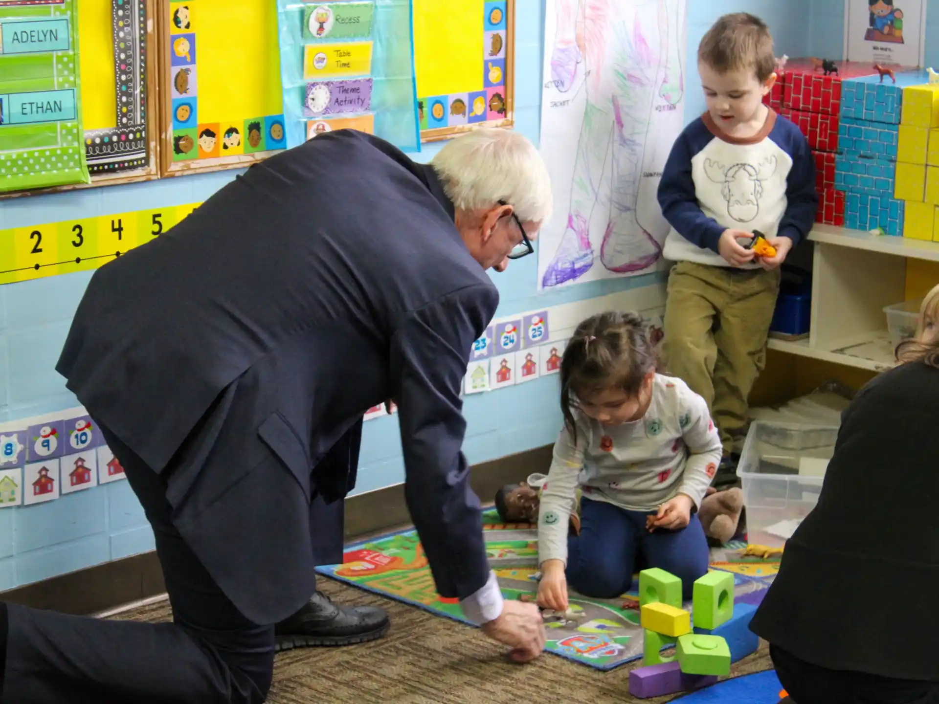 a person and children playing with toys