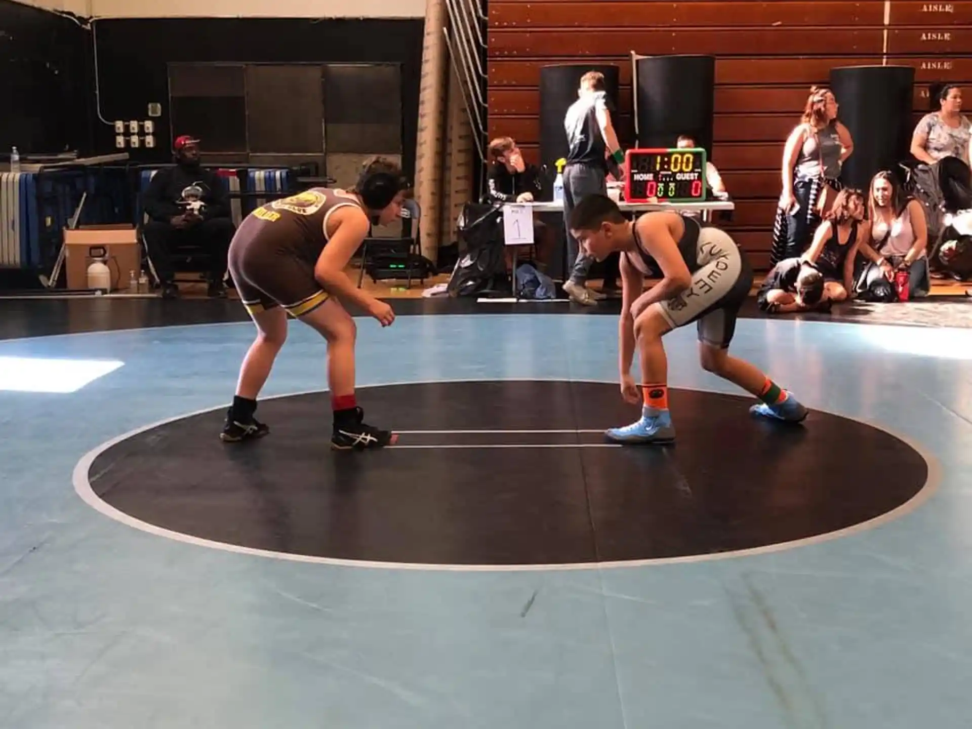 a couple of men wrestling in a gym