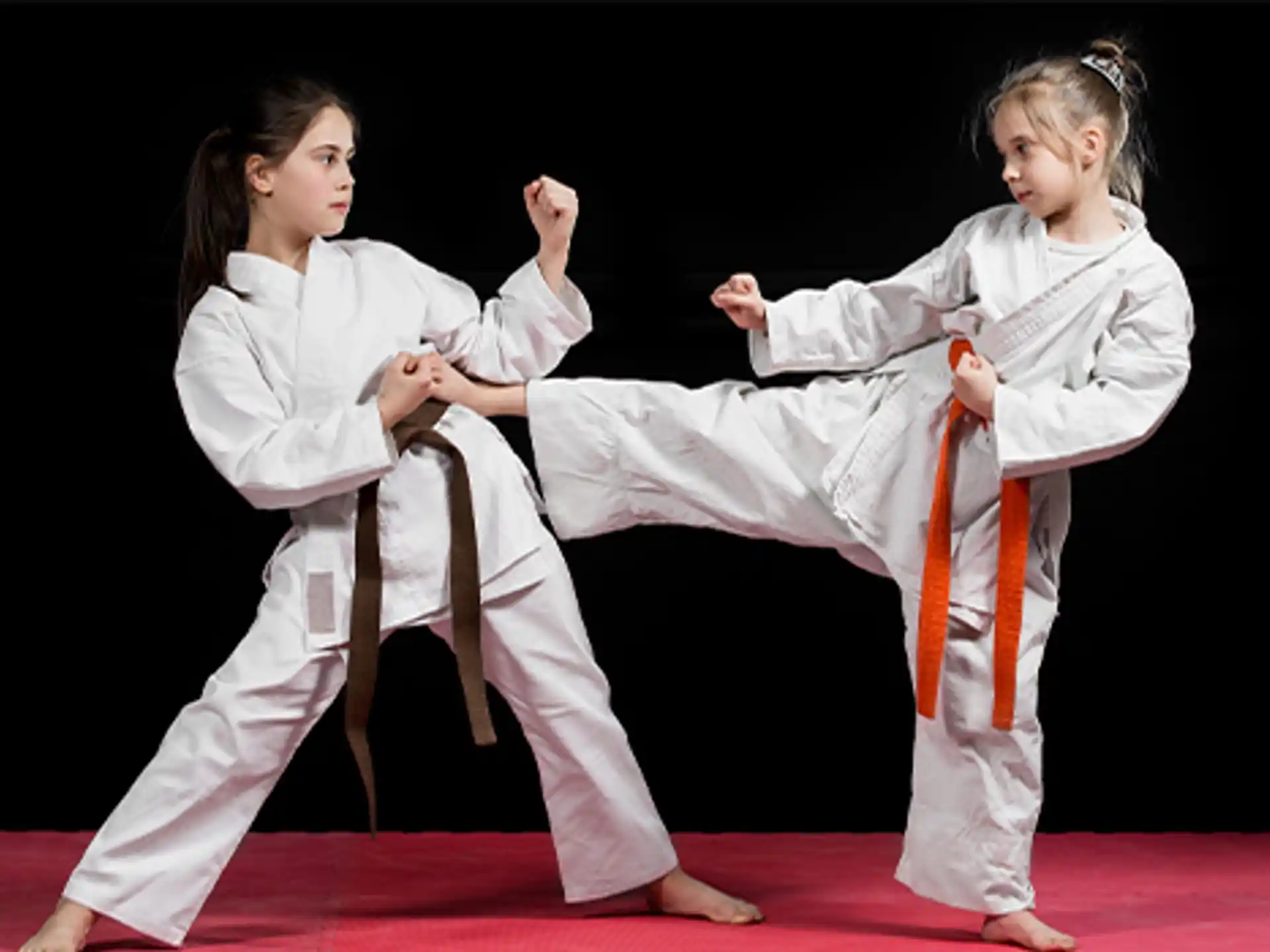 a group of girls in karate uniforms