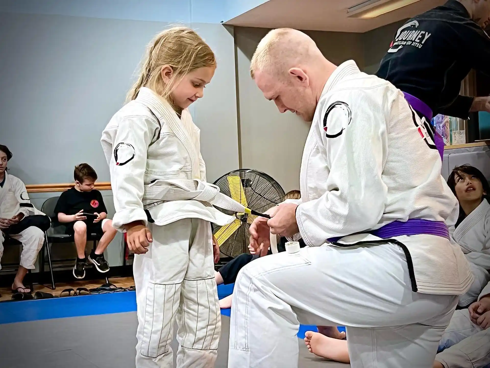 a man and a woman in karate uniforms