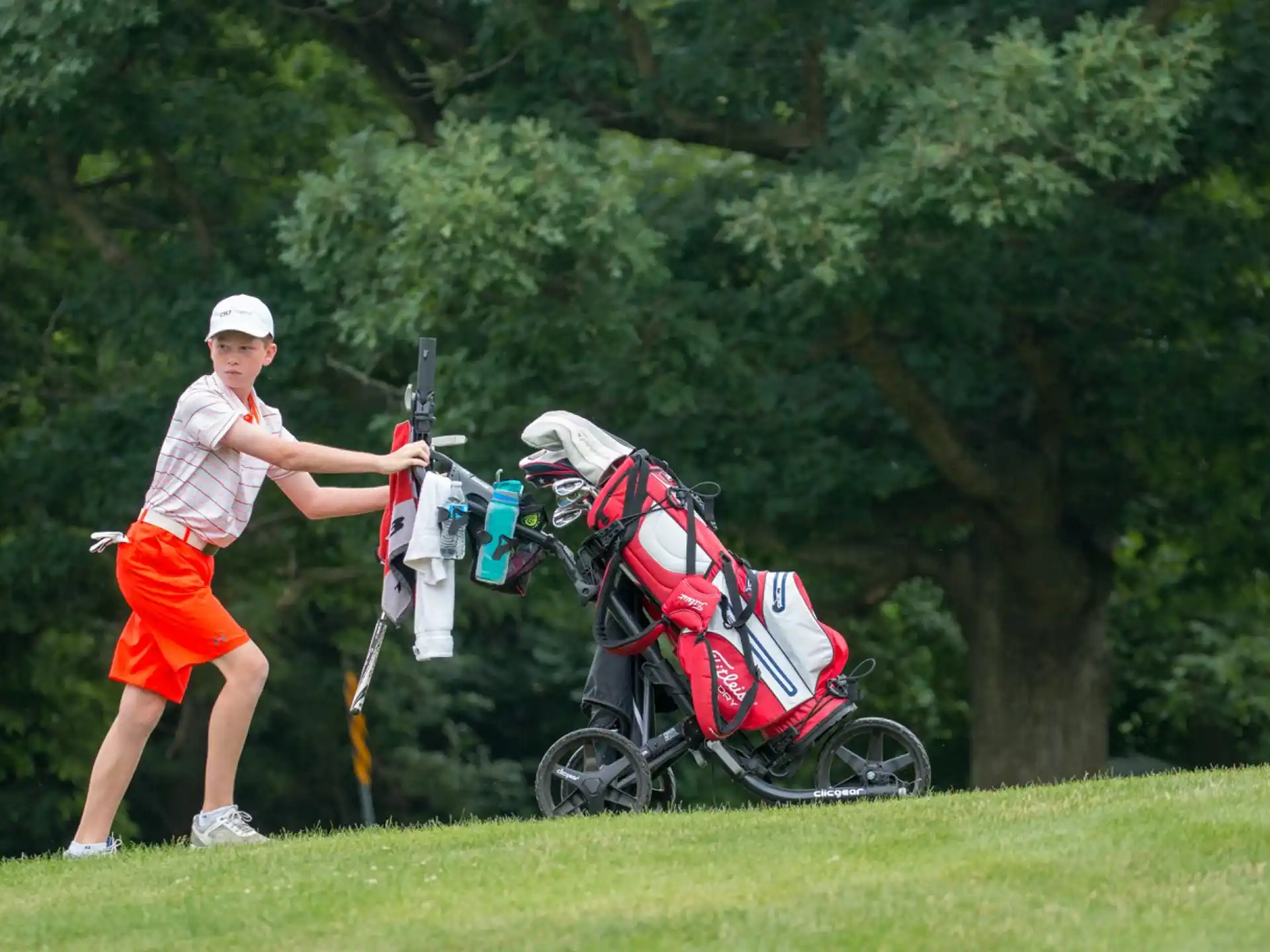 a person pushing a golf cart