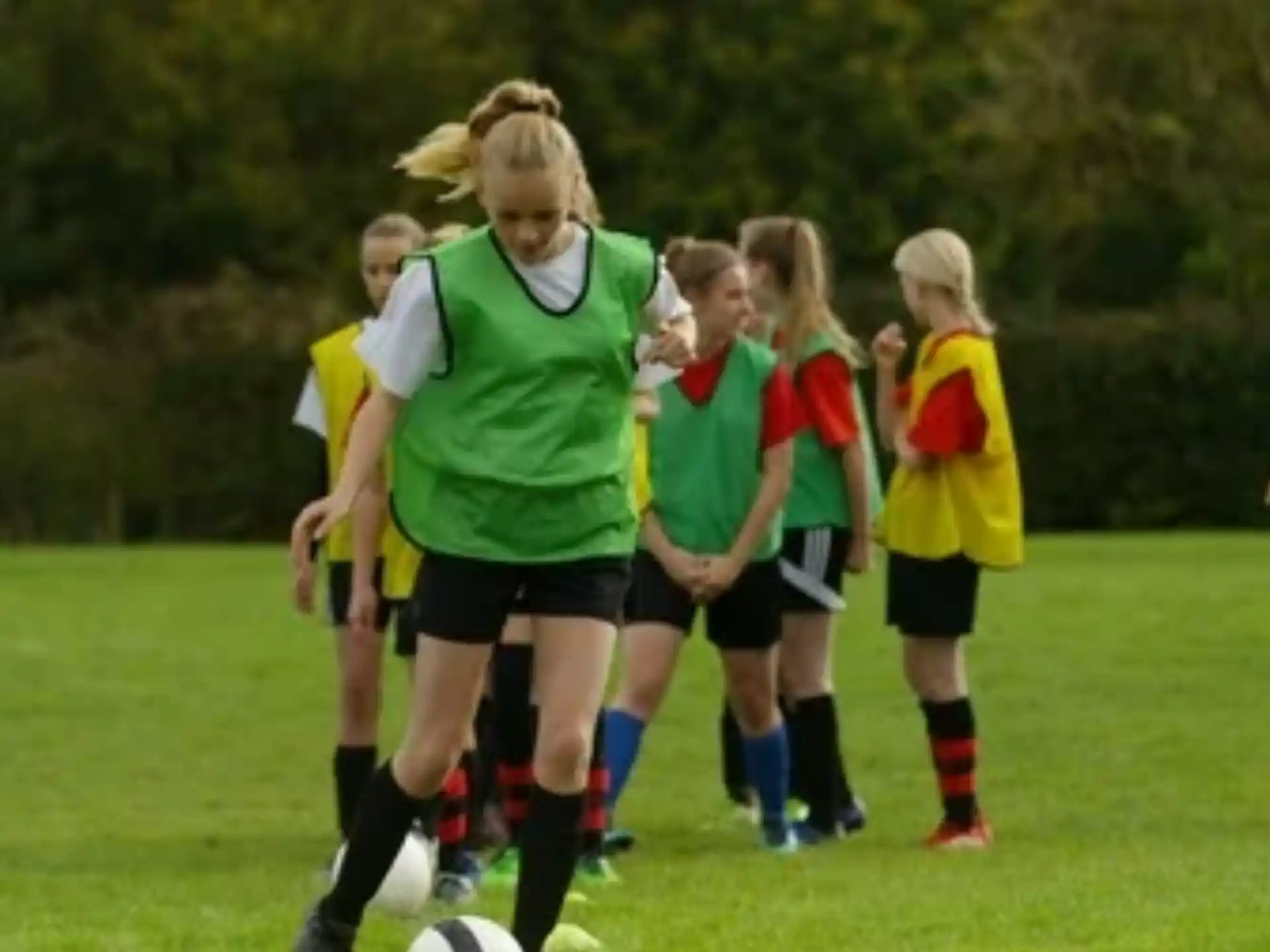a group of girls playing football