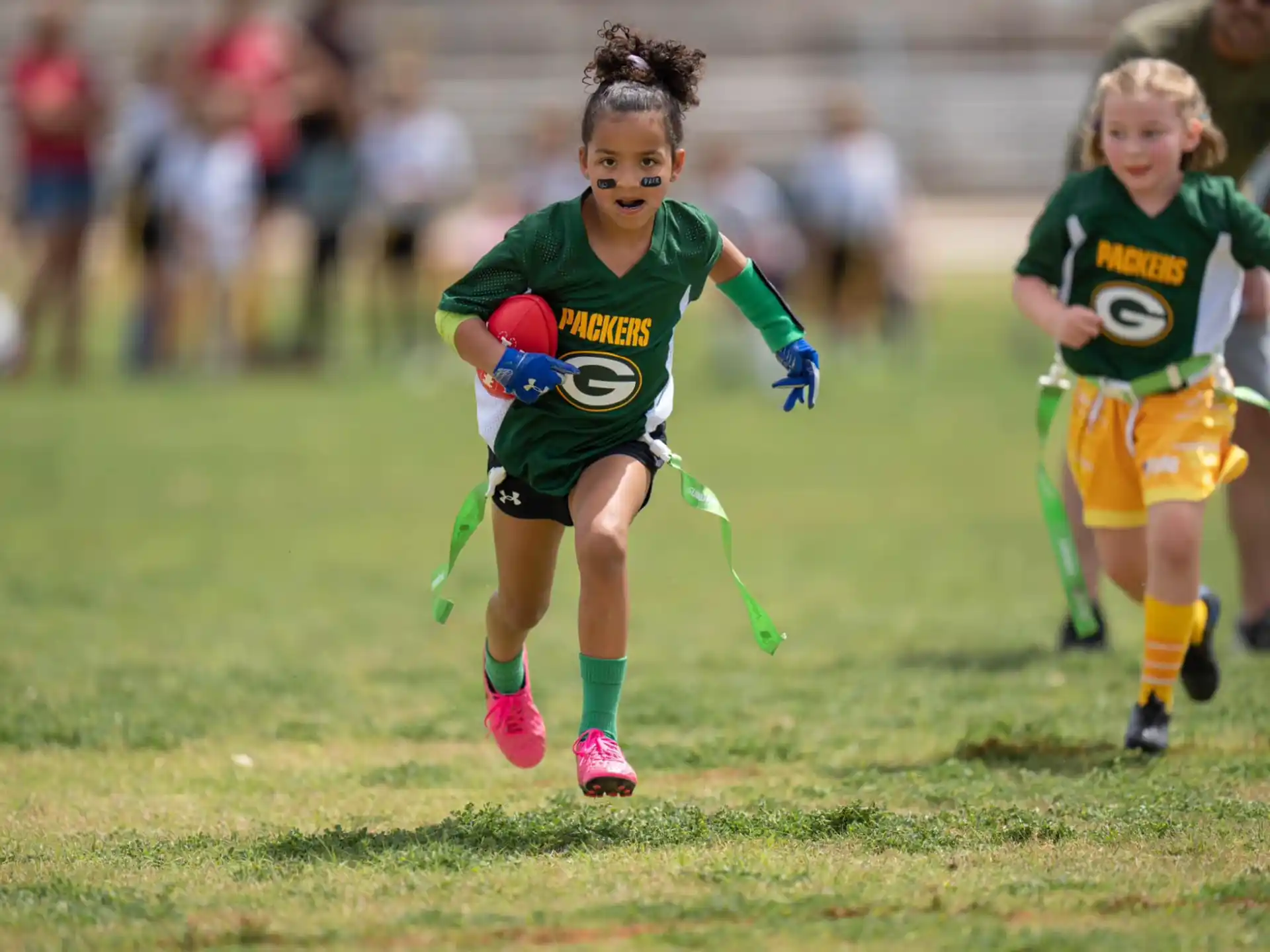 a group of girls running on a field