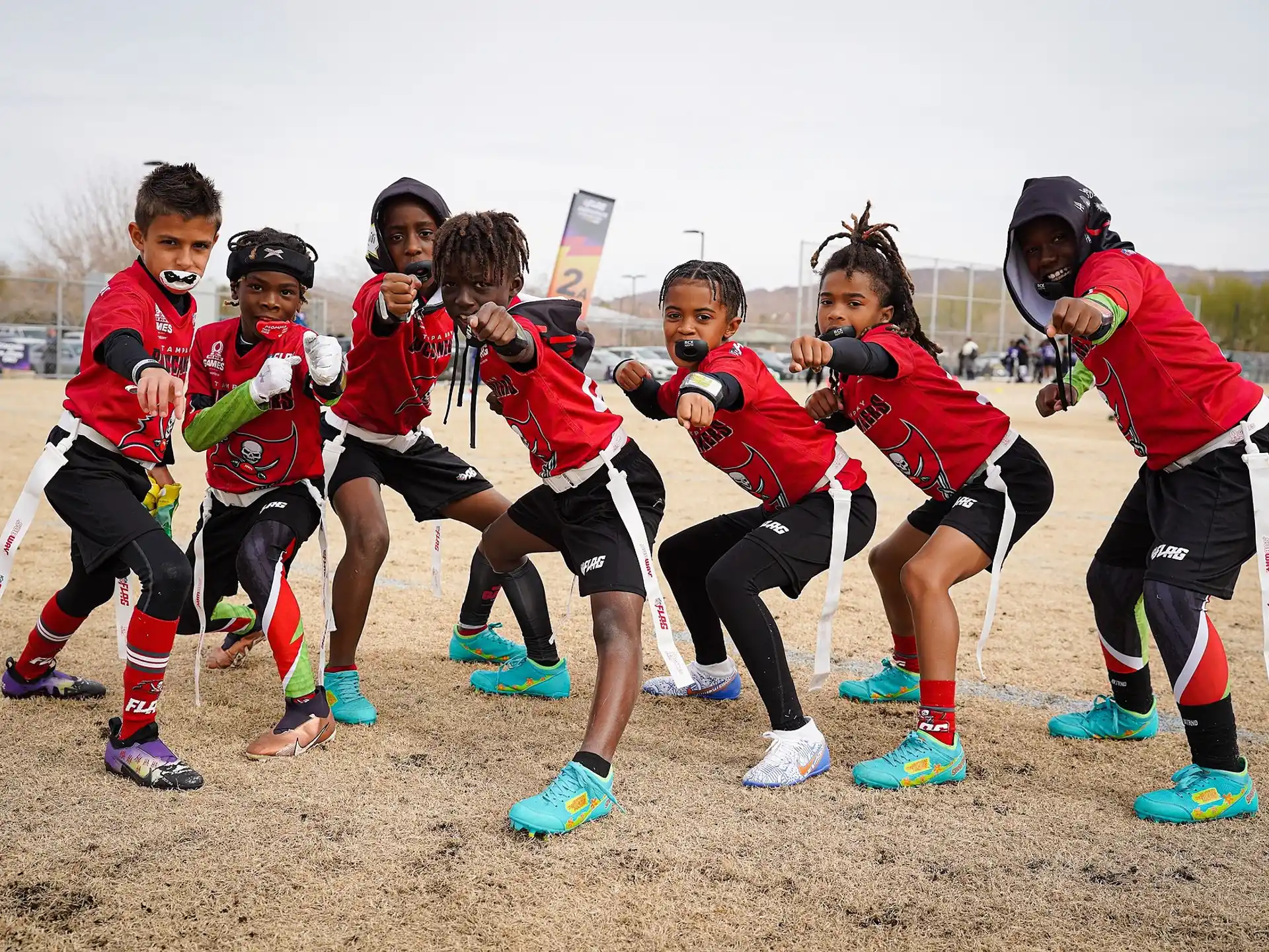 a group of people in sports uniforms running on a field