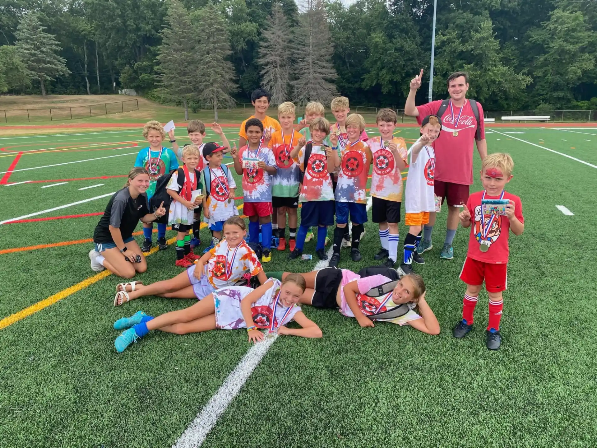a group of kids posing for a photo on a football field